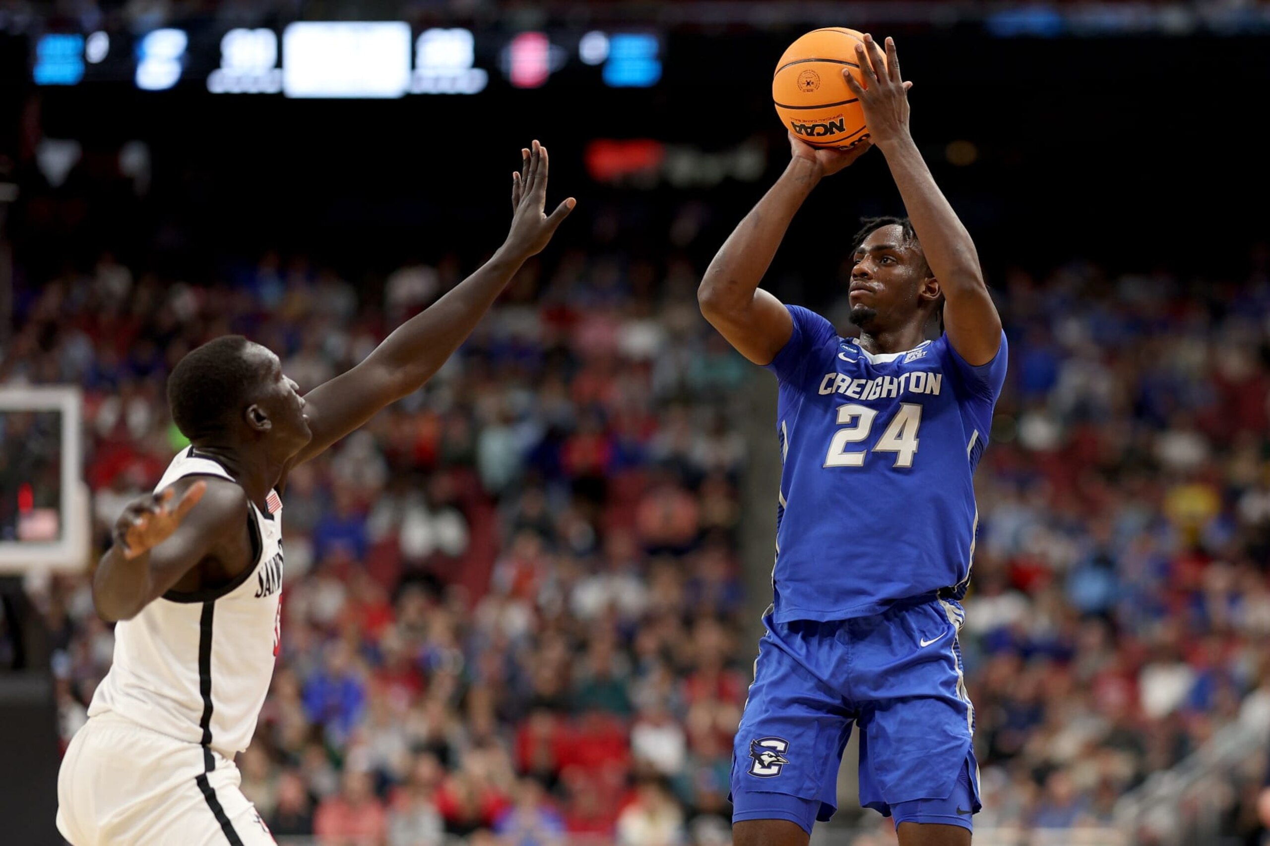 LOUISVILLE, KENTUCKY - MARCH 26: Arthur Kaluma #24 of the Creighton Bluejays shoots a three point basket against Aguek Arop #33 of the San Diego State Aztecs during the first half in the Elite Eight round of the NCAA Men's Basketball Tournament at KFC YUM! Center on March 26, 2023 in Louisville, Kentucky. (Photo by Rob Carr/Getty Images) LOUISVILLE, KENTUCKY - MARCH 26: Arthur Kaluma #24 of the Creighton Bluejays shoots a three point basket against Aguek Arop #33 of the San Diego State Aztecs during the first half in the Elite Eight round of the NCAA Men's Basketball Tournament at KFC YUM! Center on March 26, 2023 in Louisville, Kentucky. (Photo by Rob Carr/Getty Images)