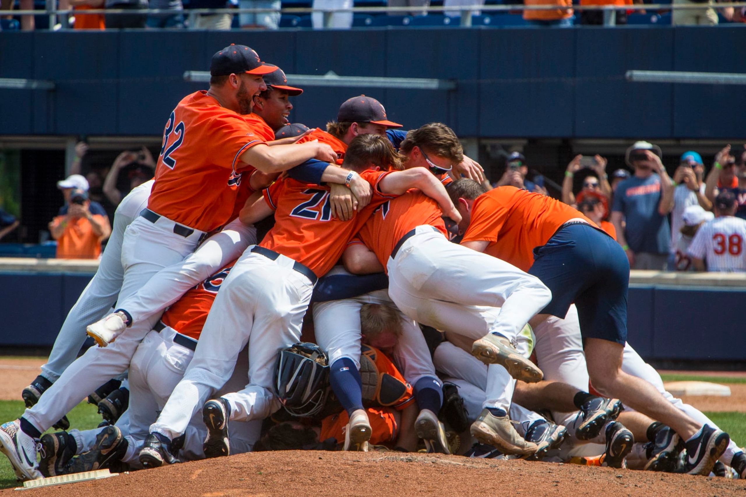 Virginia players dogpile on the pitching mound after winning an NCAA college baseball tournament super regional game against Duke on Sunday, June 11, 2023, in Charlottesville, Va. (AP Photo/John C. Clark)
