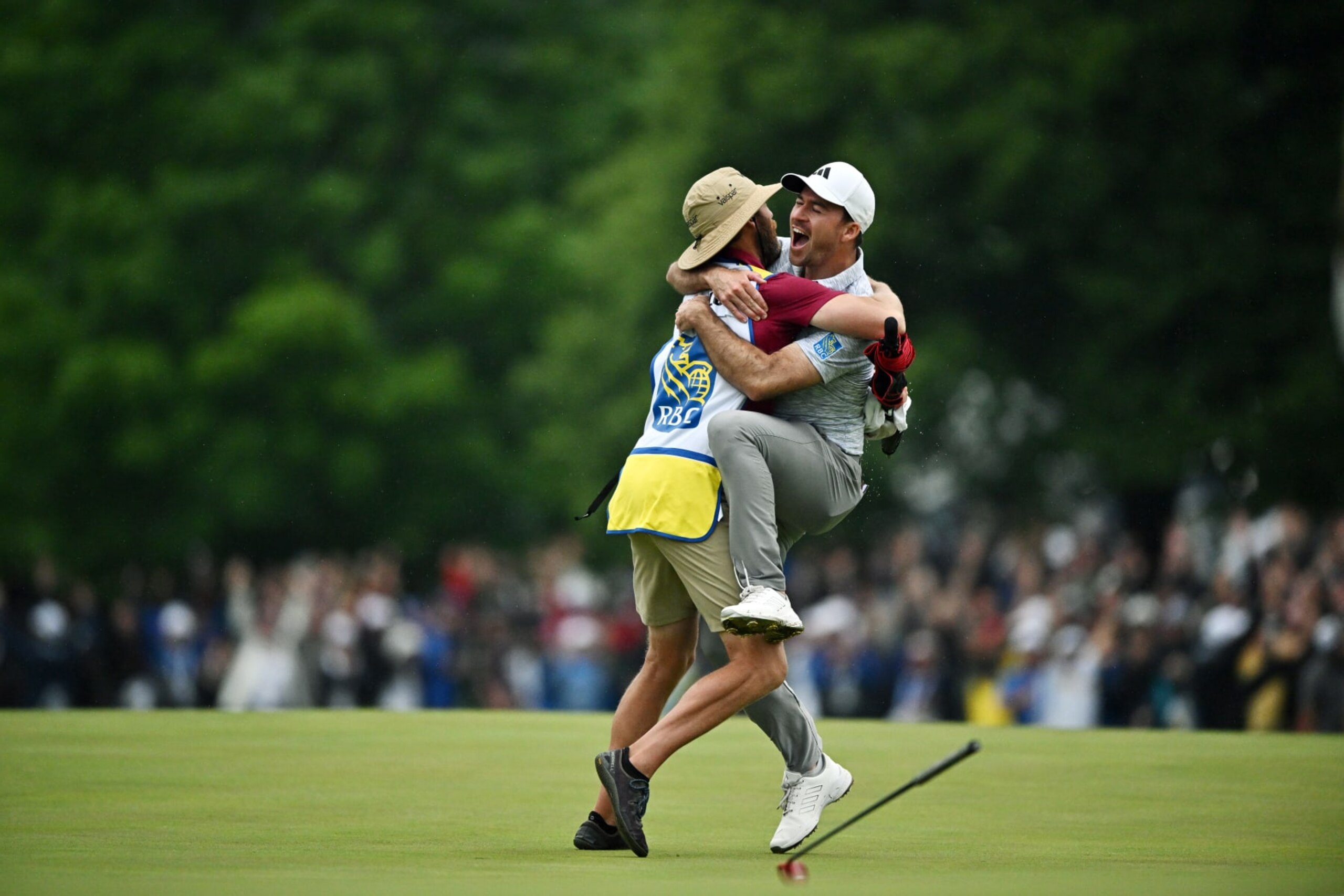 TORONTO, ONTARIO - JUNE 11:  Nick Taylor of Canada celebrates with his caddie after making an eagle putt on the 4th playoff hole to win the RBC Canadian Open at Oakdale Golf & Country Club on June 11, 2023 in Toronto, Ontario. (Photo by Minas Panagiotakis/Getty Images)
