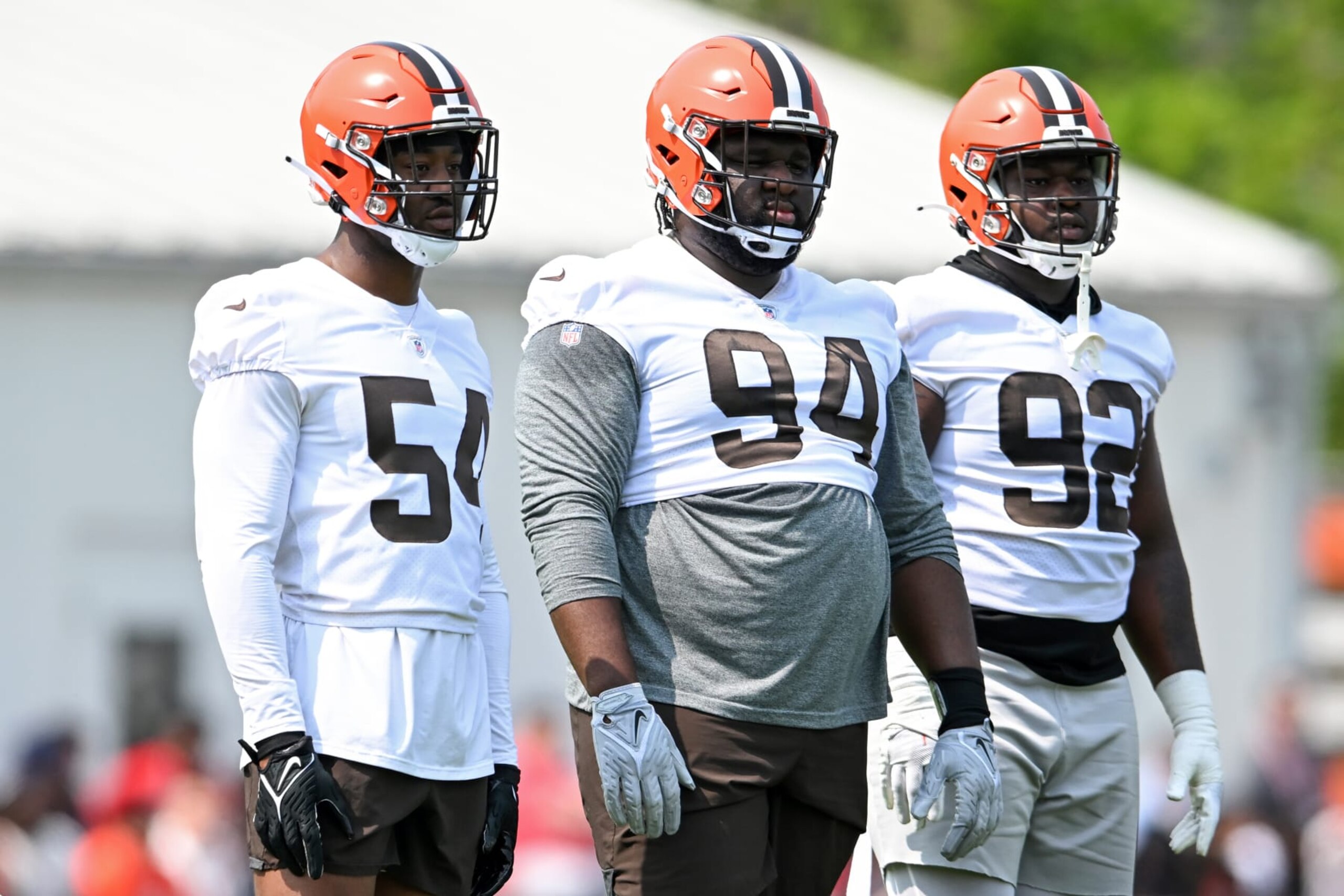 BEREA, OHIO - MAY 24: Ogbonnia Okoronkwo #54, Dalvin Tomlinson #94 and Sam Kamara #92 of the Cleveland Browns watch a drill during the Cleveland Browns OTAs at CrossCountry Mortgage Campus on May 24, 2023 in Berea, Ohio. (Photo by Nick Cammett/Diamond Images via Getty Images)