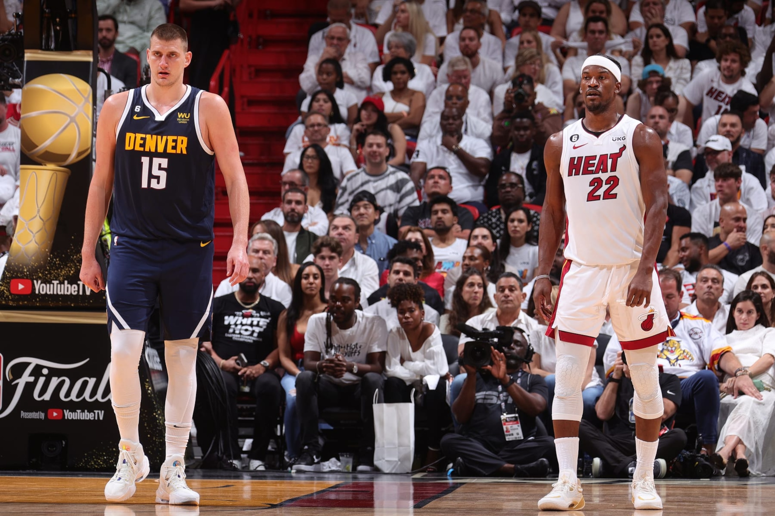 MIAMI, FL - JUNE 9: Nikola Jokic #15 of the Denver Nuggets and Jimmy Butler #22 of the Miami Heat look on during Game Four of the 2023 NBA Finals on June 9, 2023 at Kaseya Center in Miami, Florida. NOTE TO USER: User expressly acknowledges and agrees that, by downloading and or using this Photograph, user is consenting to the terms and conditions of the Getty Images License Agreement. Mandatory Copyright Notice: Copyright 2023 NBAE (Photo by Nathaniel S. Butler/NBAE via Getty Images)