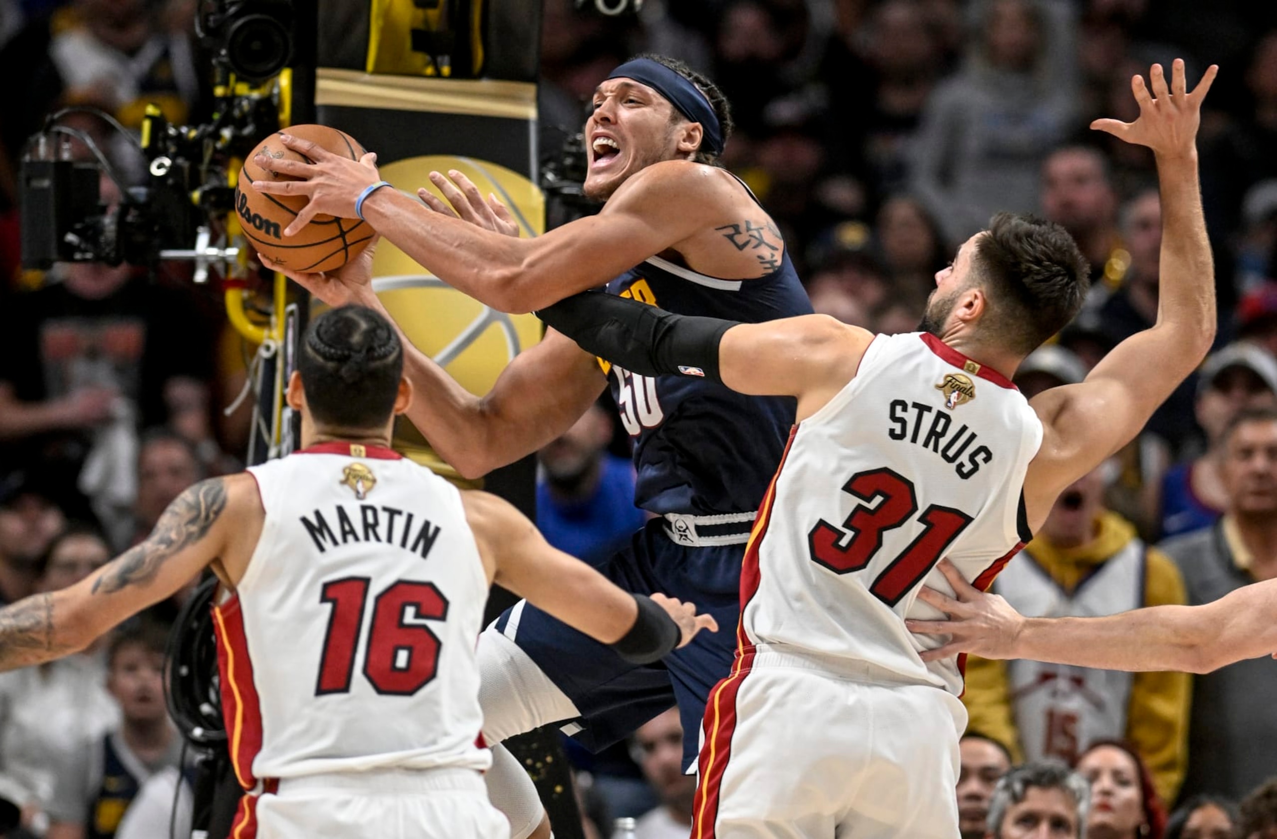 DENVER, CO - JUNE 4: Aaron Gordon (50) of the Denver Nuggets passes as Caleb Martin (16) and Max Strus (31) of the Miami Heat defend in the first quarter during Game 2 of the NBA Finals at Ball Arena in Denver on Sunday, June 4, 2023. (Photo by AAron Ontiveroz/The Denver Post)