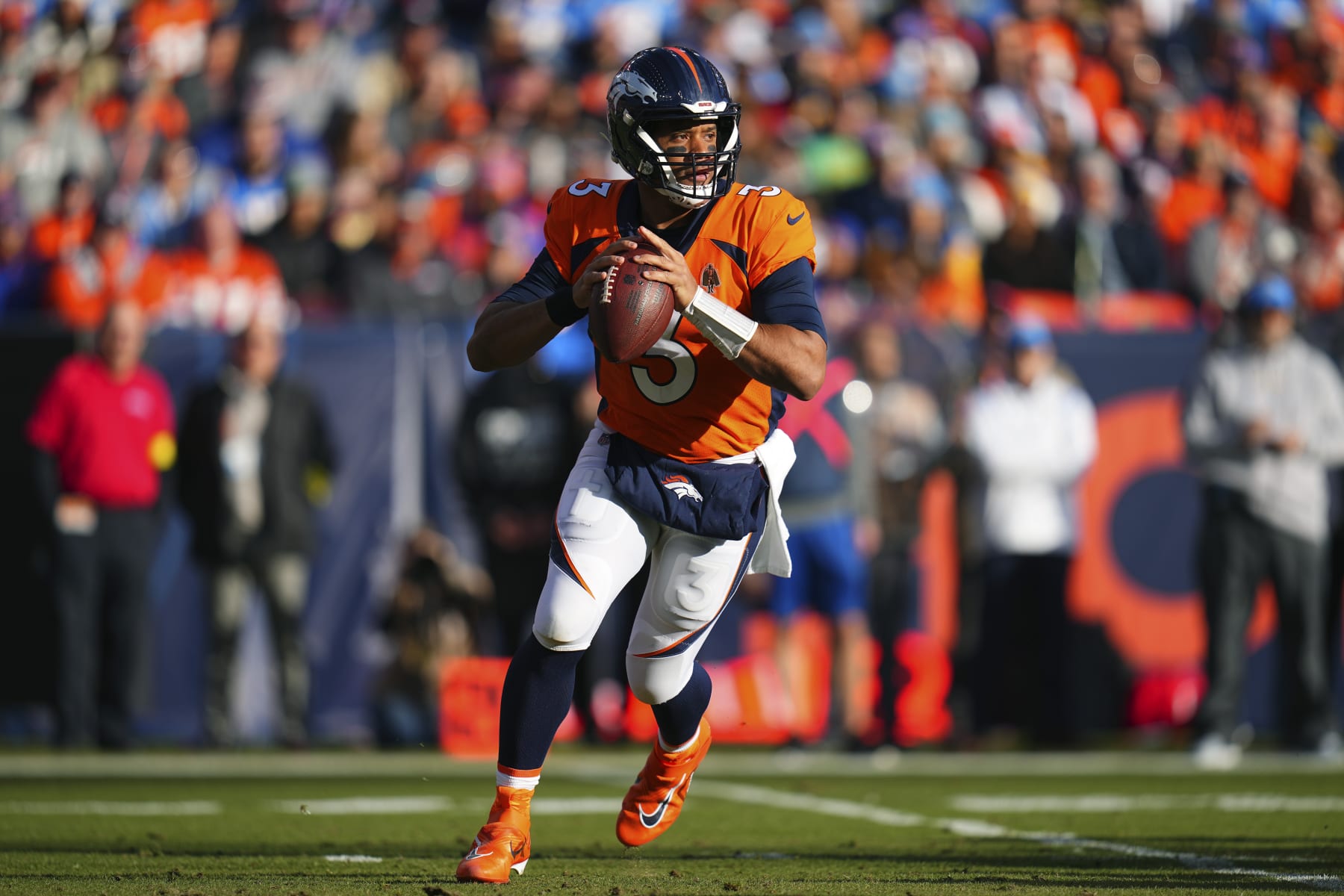 Denver Broncos quarterback Russell Wilson (3) looks to throw against the Los Angeles Chargers during the first half of an NFL football game in Denver, Sunday, Jan. 8, 2023. (AP Photo/Jack Dempsey)