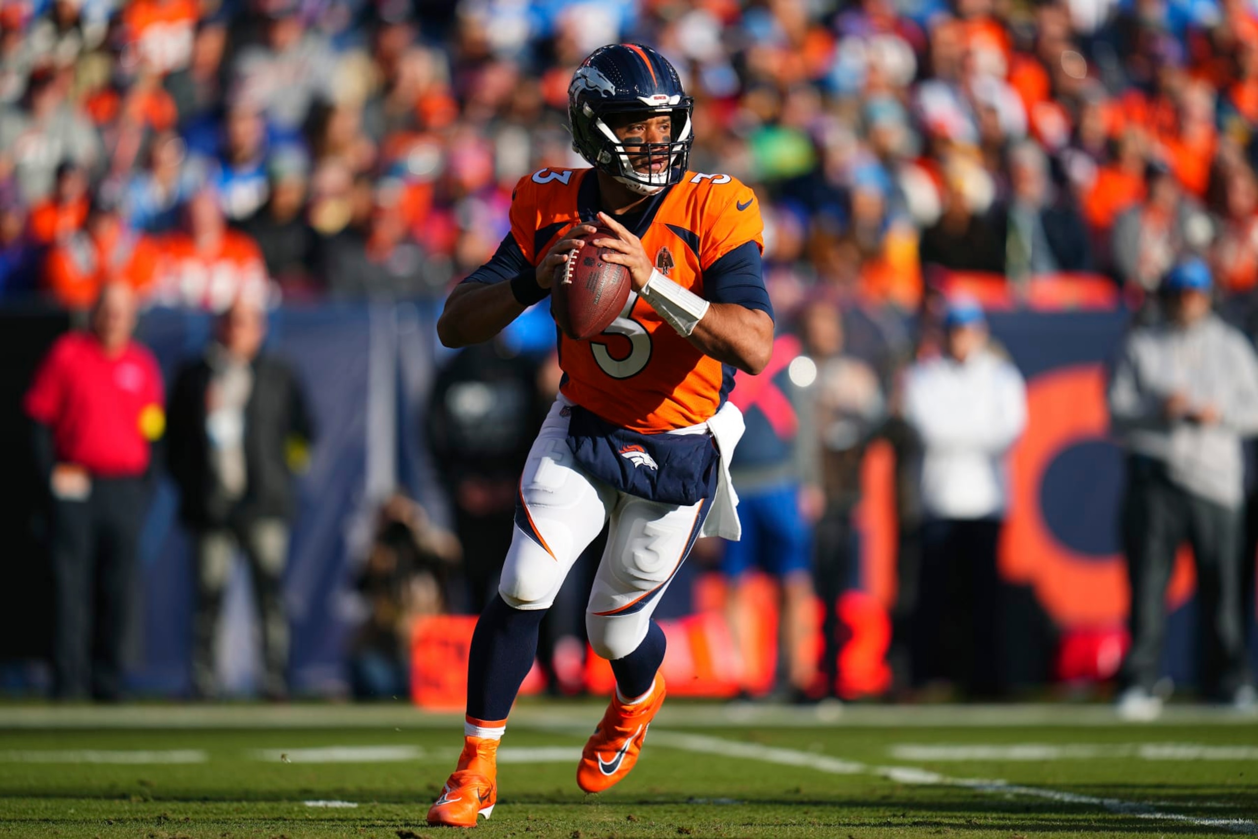 Denver Broncos quarterback Russell Wilson (3) looks to throw against the Los Angeles Chargers during the first half of an NFL football game in Denver, Sunday, Jan. 8, 2023. (AP Photo/Jack Dempsey)