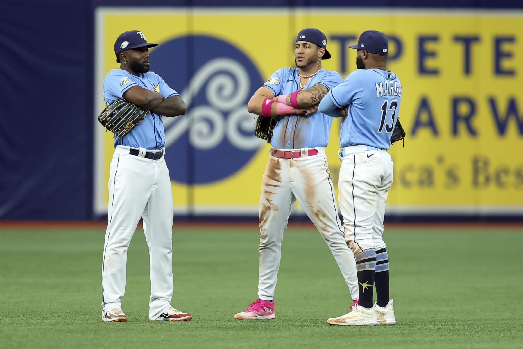 Tampa Bay Rays' Randy Arozarena, left, celebrates with Jose Siri and Manuel Margot after a win over the Texas Rangers in a baseball game Sunday, June 11, 2023, in St. Petersburg, Fla. (AP Photo/Mike Carlson)