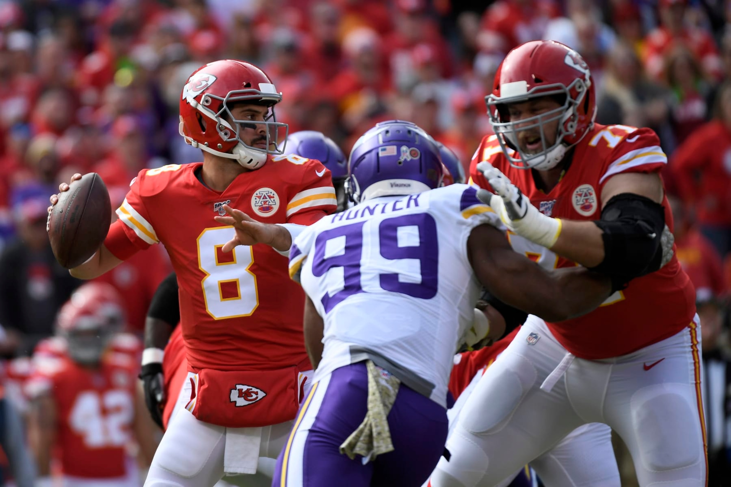 Kansas City Chiefs quarterback Matt Moore (8) looks for a receiver as offensive tackle Mitchell Schwartz (71) blocks Minnesota Vikings defensive end Danielle Hunter (99) during the first half of an NFL football game in Kansas City, Mo., Sunday, Nov. 3, 2019. (AP Photo/Reed Hoffmann)