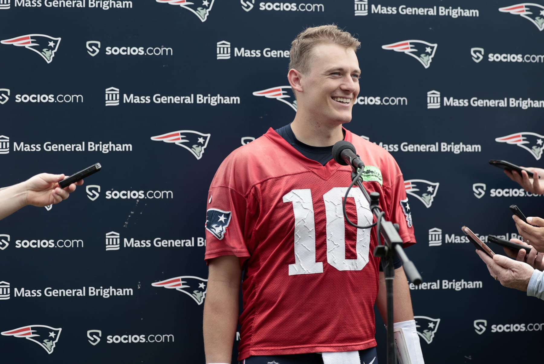 FOXBOROUGH, MA - JUNE 12: New England Patriots quarterback Mac Jones (10) reacts to a question during New England Patriots Minicamp on June 12, 2023, at the Patriots Practice Facility at Gillette Stadium in Foxborough, Massachusetts. (Photo by Fred Kfoury III/Icon Sportswire via Getty Images)