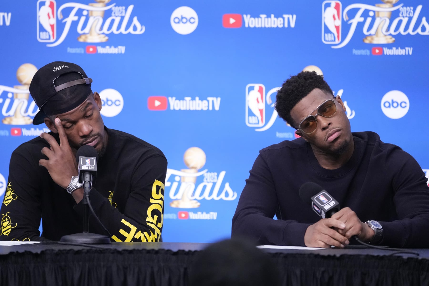 Miami Heat forward Jimmy Butler (22) and guard Kyle Lowry (7) reacts a news conference following Game 4 of the basketball NBA Finals against the Denver Nuggets, Saturday, June 10, 2023, in Miami. The Nuggets defeated the Heat 108-95. (AP Photo/Lynne Sladky)