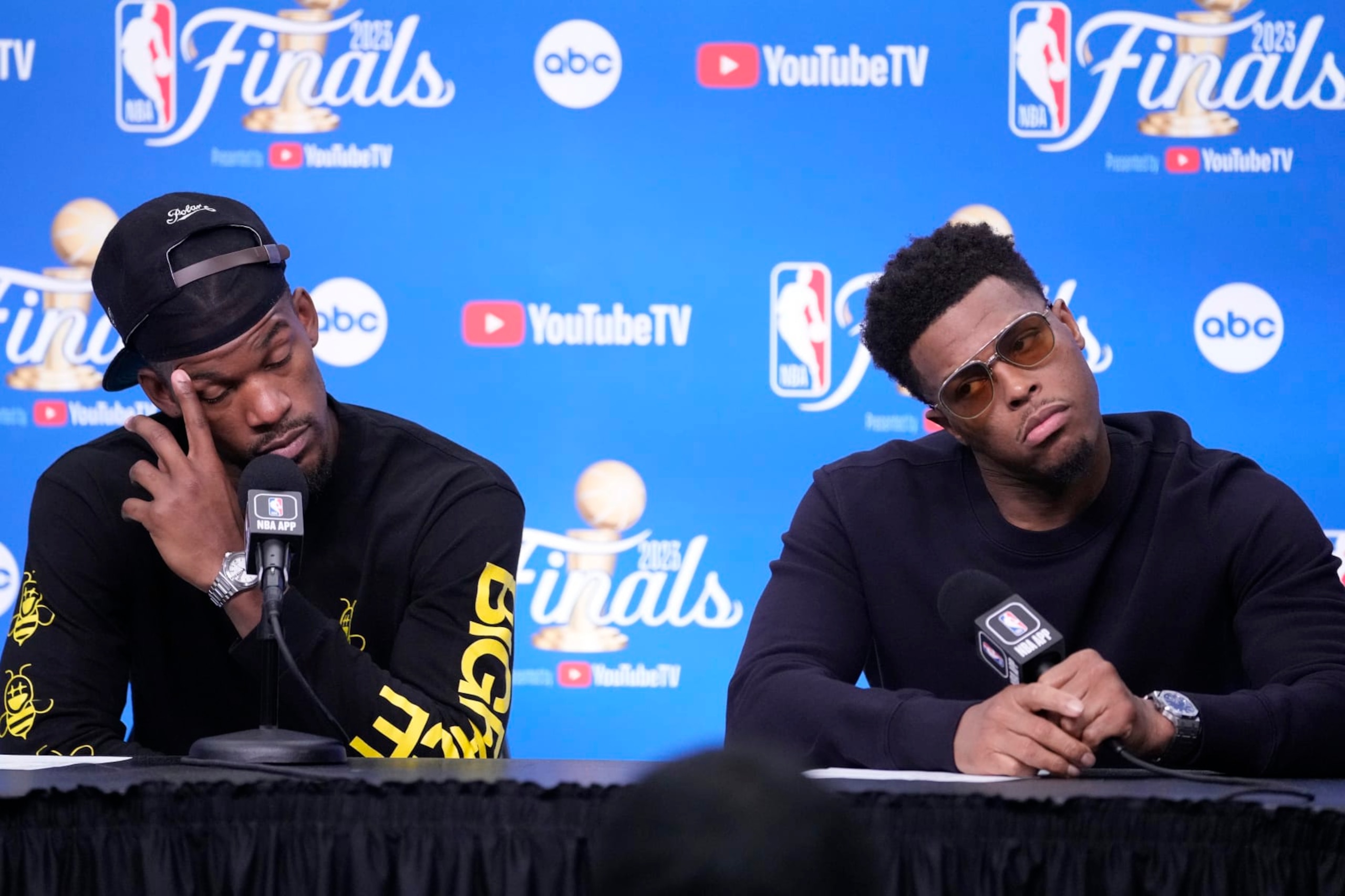 Miami Heat forward Jimmy Butler (22) and guard Kyle Lowry (7) reacts a news conference following Game 4 of the basketball NBA Finals against the Denver Nuggets, Saturday, June 10, 2023, in Miami. The Nuggets defeated the Heat 108-95. (AP Photo/Lynne Sladky)