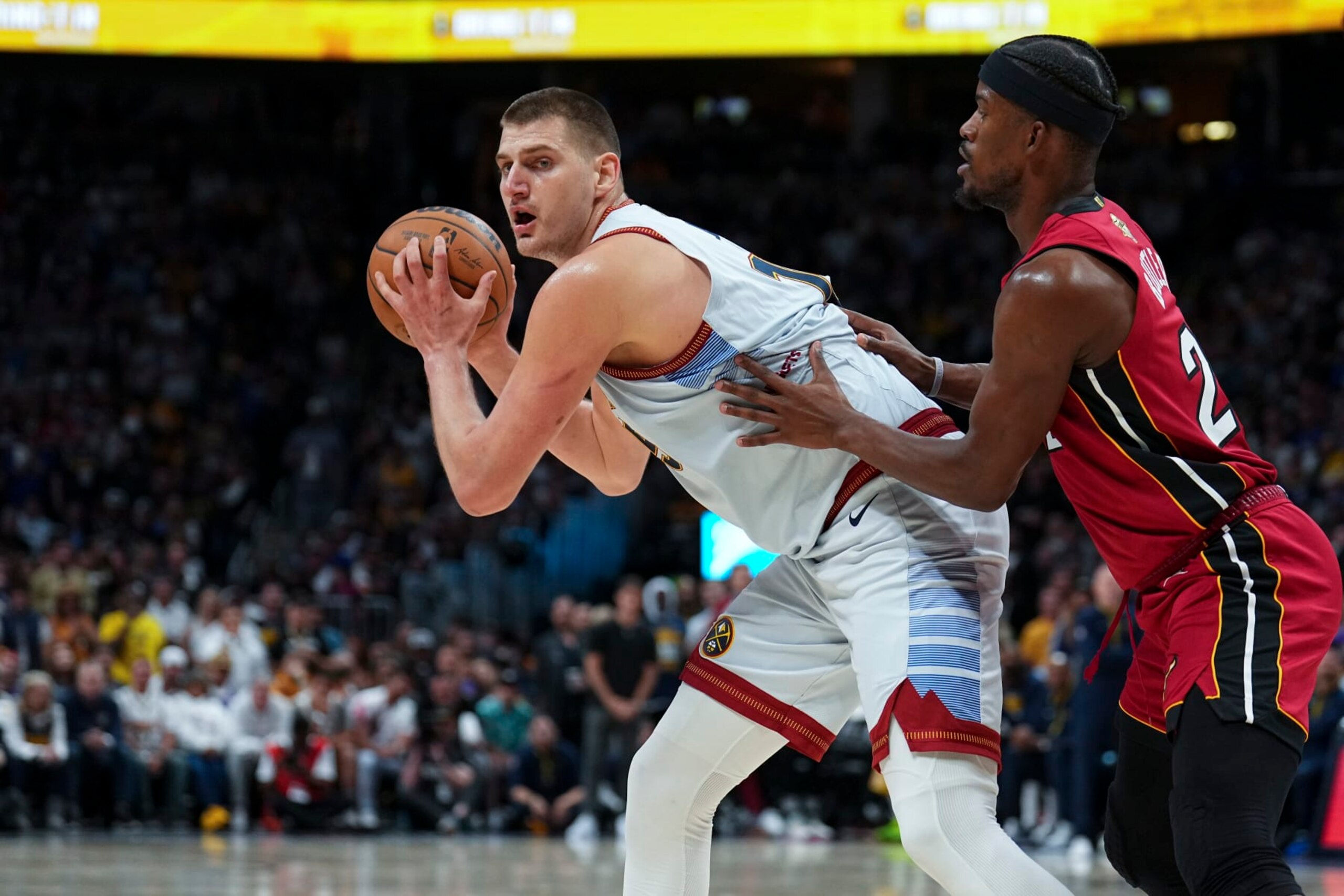 Denver Nuggets center Nikola Jokic, left, is defended by Miami Heat forward Jimmy Butler, right, during the second half of Game 5 of basketball's NBA Finals, Monday, June 12, 2023, in Denver. (AP Photo/Jack Dempsey)