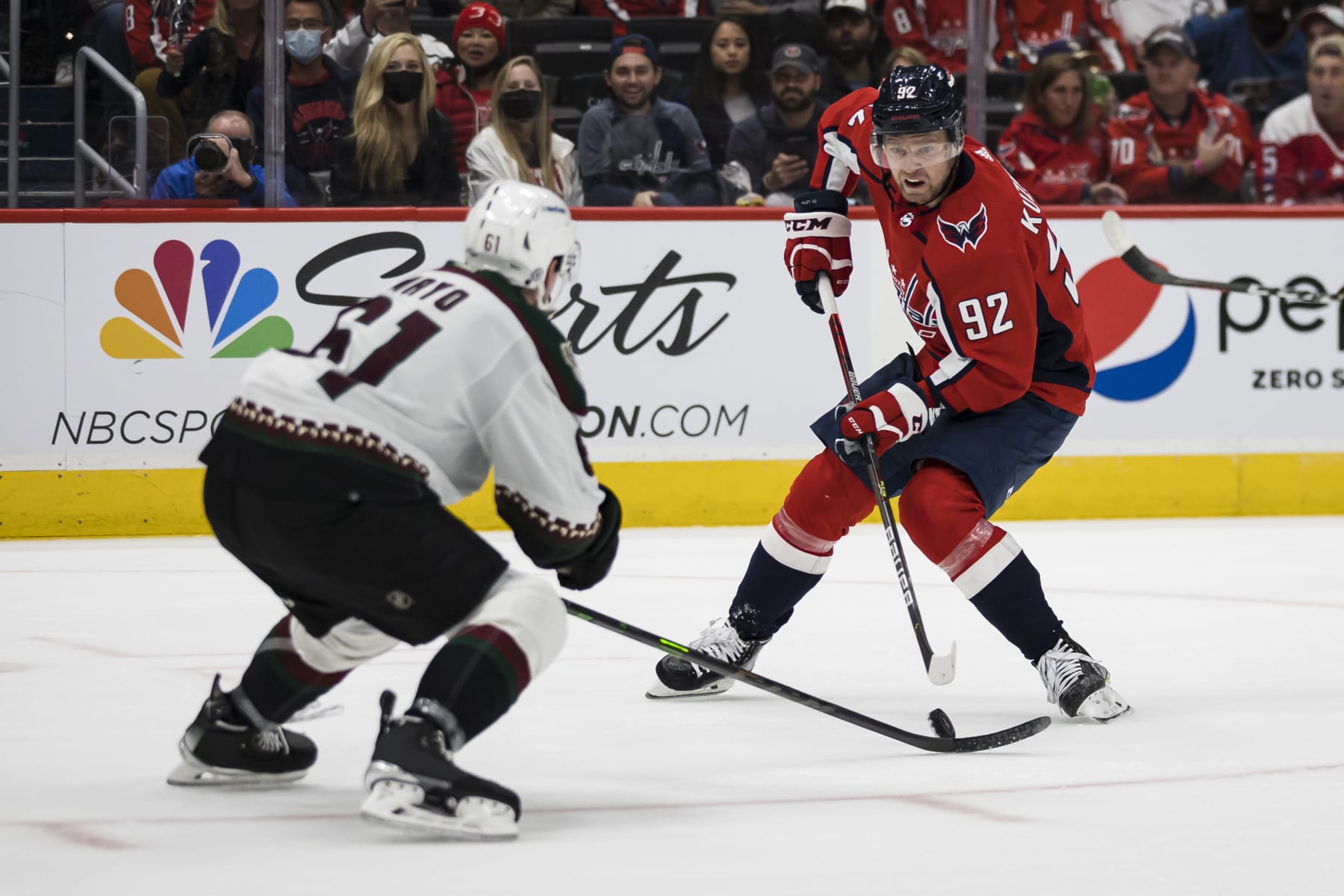 WASHINGTON, DC - OCTOBER 29: Evgeny Kuznetsov #92 of the Washington Capitals handles the puck against Dysin Mayo #61 of the Arizona Coyotes during the second period of the game at Capital One Arena on October 29, 2021 in Washington, DC. (Photo by Scott Taetsch/Getty Images)