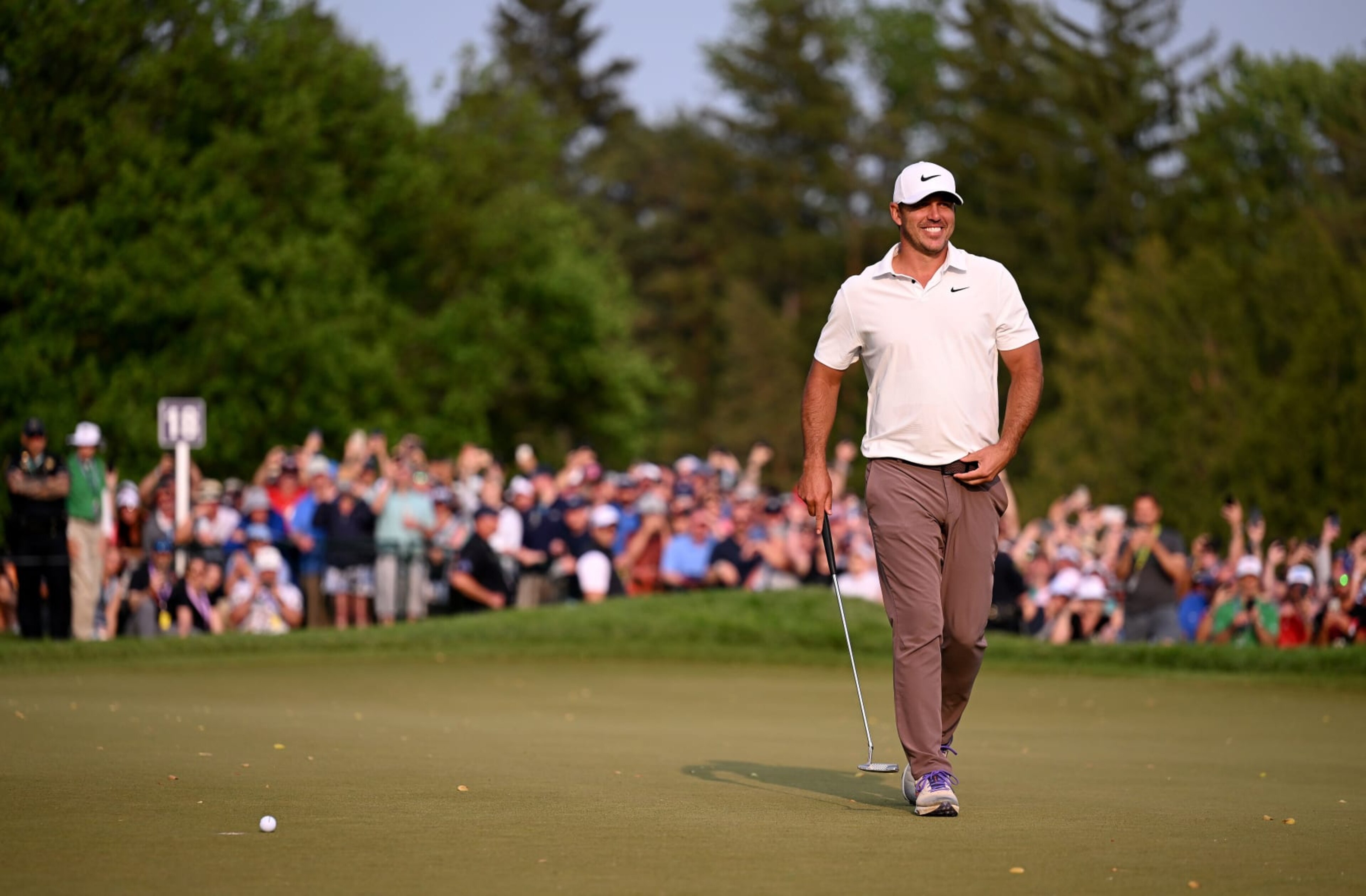 ROCHESTER, NEW YORK - MAY 21: Brooks Koepka of the United States smiles on the 18th green before his final putt to win during the final round of the 2023 PGA Championship at Oak Hill Country Club on May 21, 2023 in Rochester, New York. (Photo by Ross Kinnaird/Getty Images)