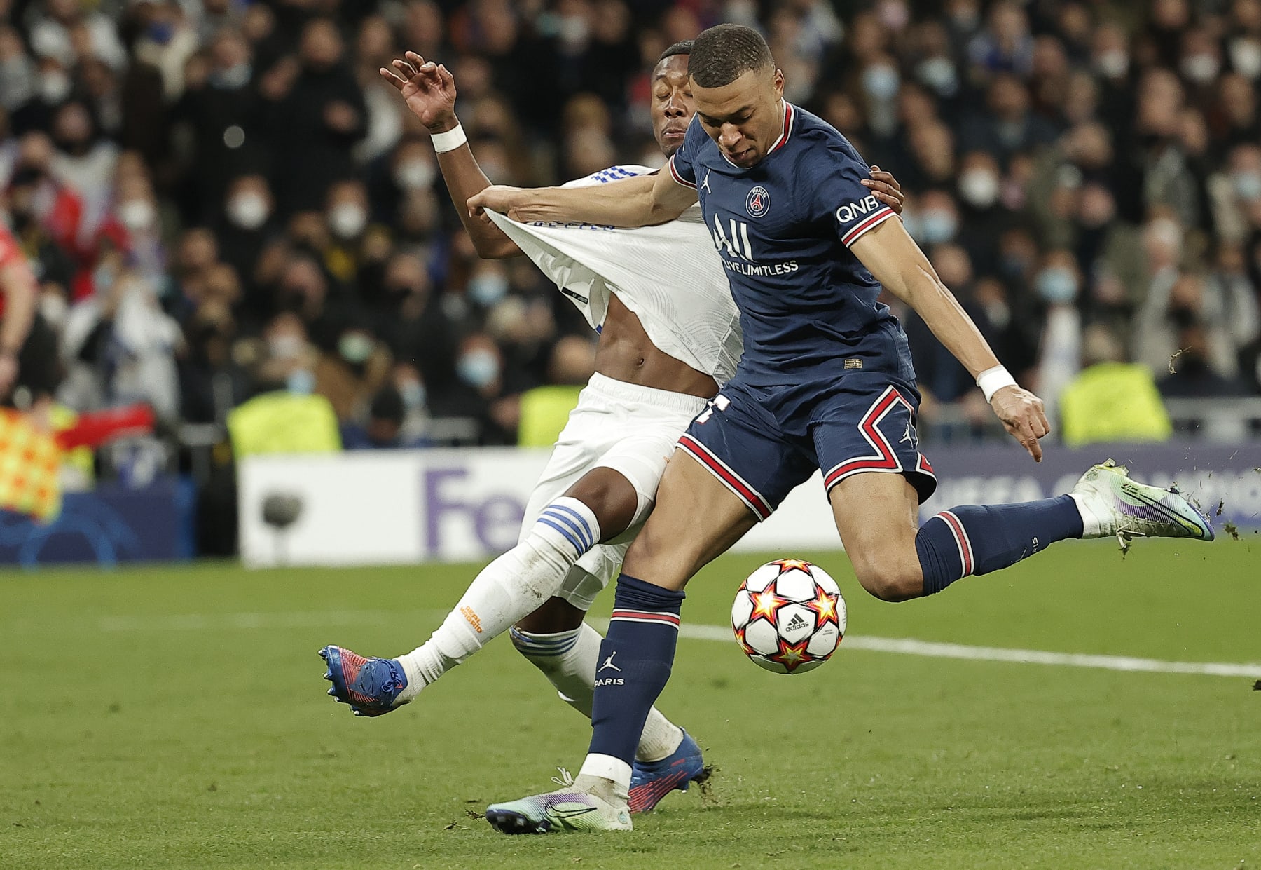 MADRID, SPAIN - MARCH 9: Kylian Mbappe (C) of Paris Saint-Germain in action against David Alaba (L) of Real Madrid during the UEFA Champions League round of sixteen leg two match between Real Madrid and Paris Saint-Germain at Estadio Santiago Bernabeu on March 09, 2022 in Madrid, Spain. (Photo by Burak Akbulut/Anadolu Agency via Getty Images)