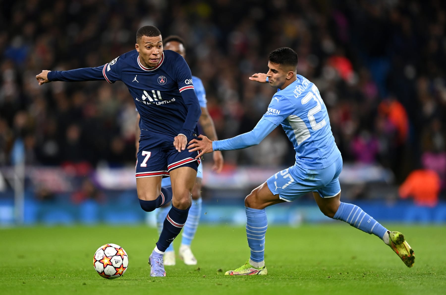MANCHESTER, ENGLAND - NOVEMBER 24:  Kylian Mbappe of Paris Saint-Germain is challenged by Joao Cancelo of Manchester City during the UEFA Champions League group A match between Manchester City and Paris Saint-Germain at Etihad Stadium on November 24, 2021 in Manchester, England. (Photo by Shaun Botterill/Getty Images)