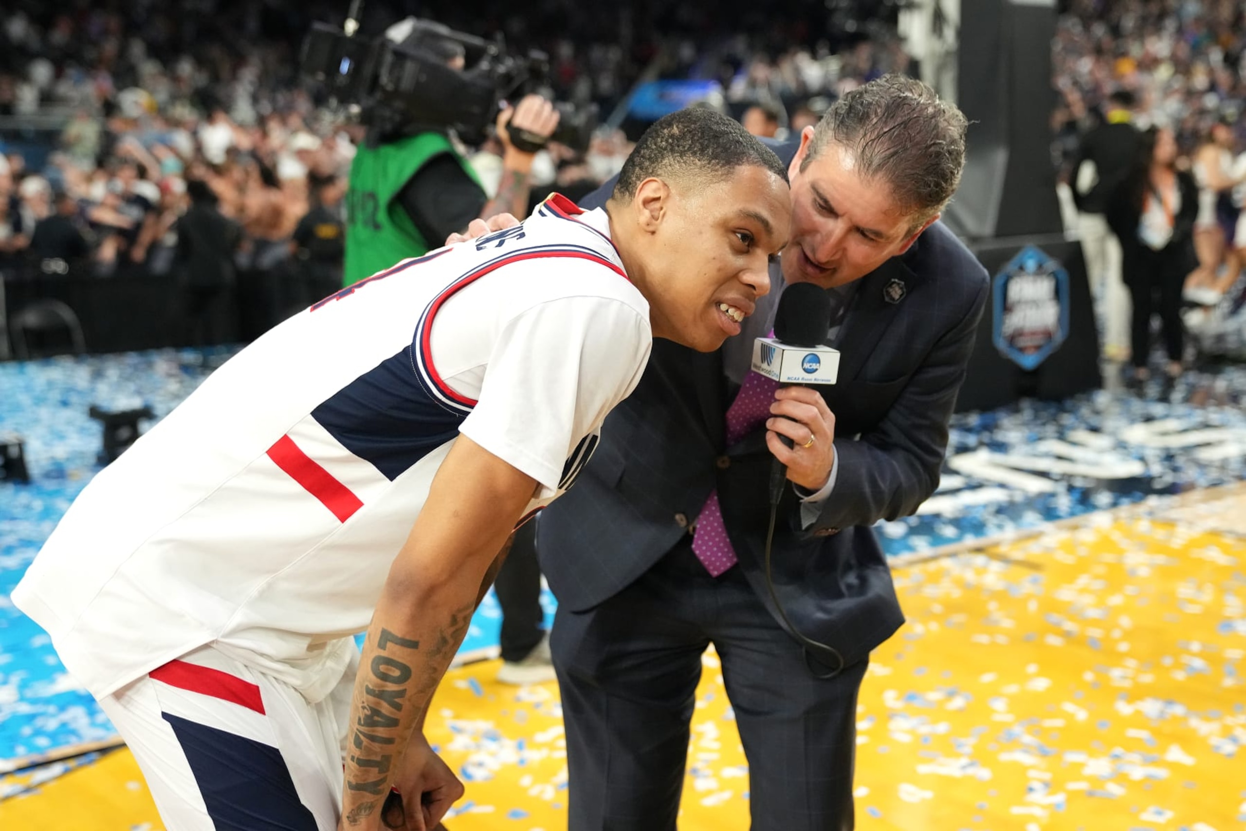 HOUSTON, TEXAS - APRIL 03: Jordan Hawkins #24 of the Connecticut Huskies is interviewed by Andy Katz after winning the NCAA Men's Basketball Tournament Final Four championship game against the San Diego State Aztecs at NRG Stadium on April 03, 2023 in Houston, Texas. (Photo by Mitchell Layton/Getty Images)