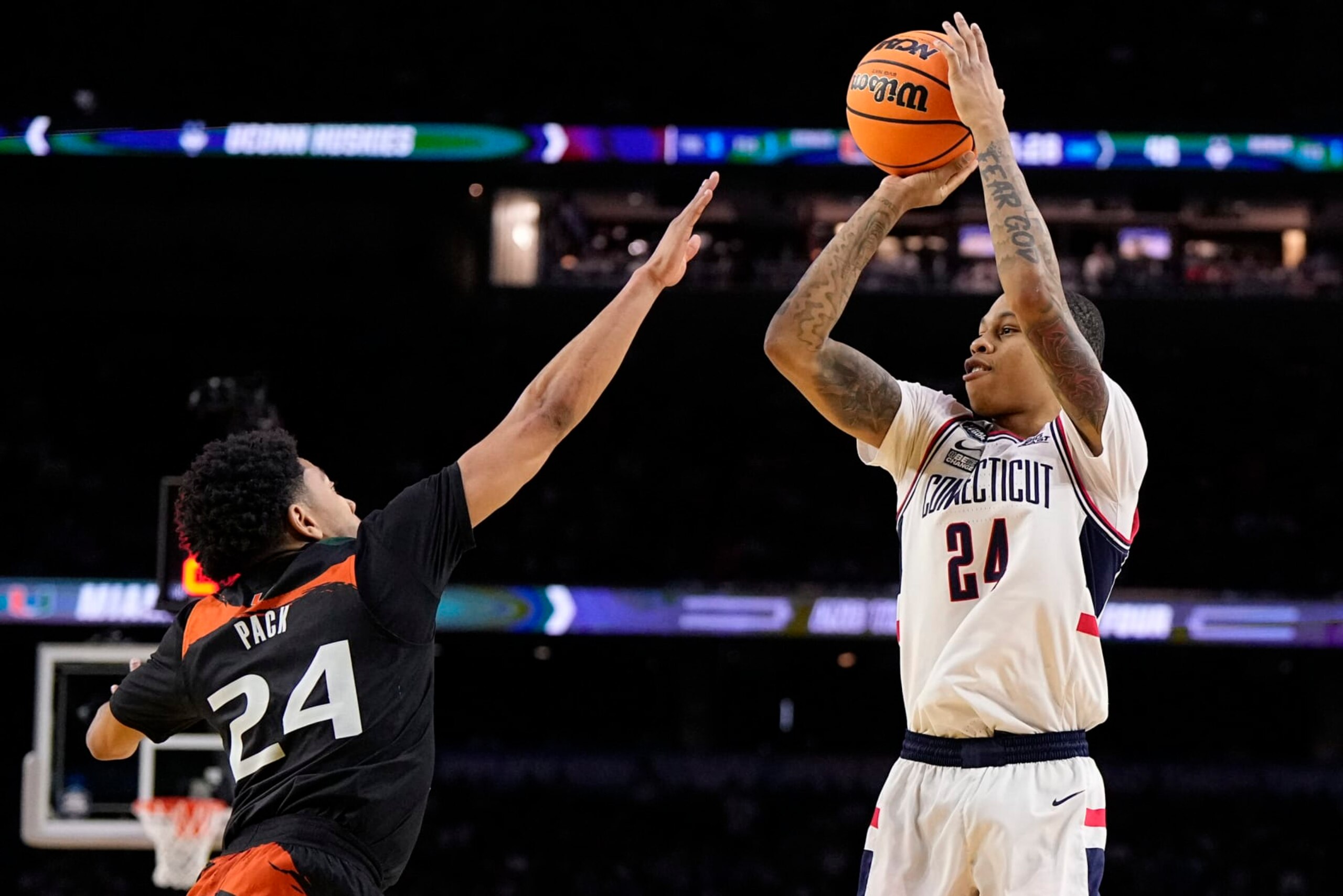 Connecticut guard Jordan Hawkins shoots over Miami guard Nijel Pack during the second half of a Final Four college basketball game in the NCAA Tournament on Saturday, April 1, 2023, in Houston. (AP Photo/Brynn Anderson)