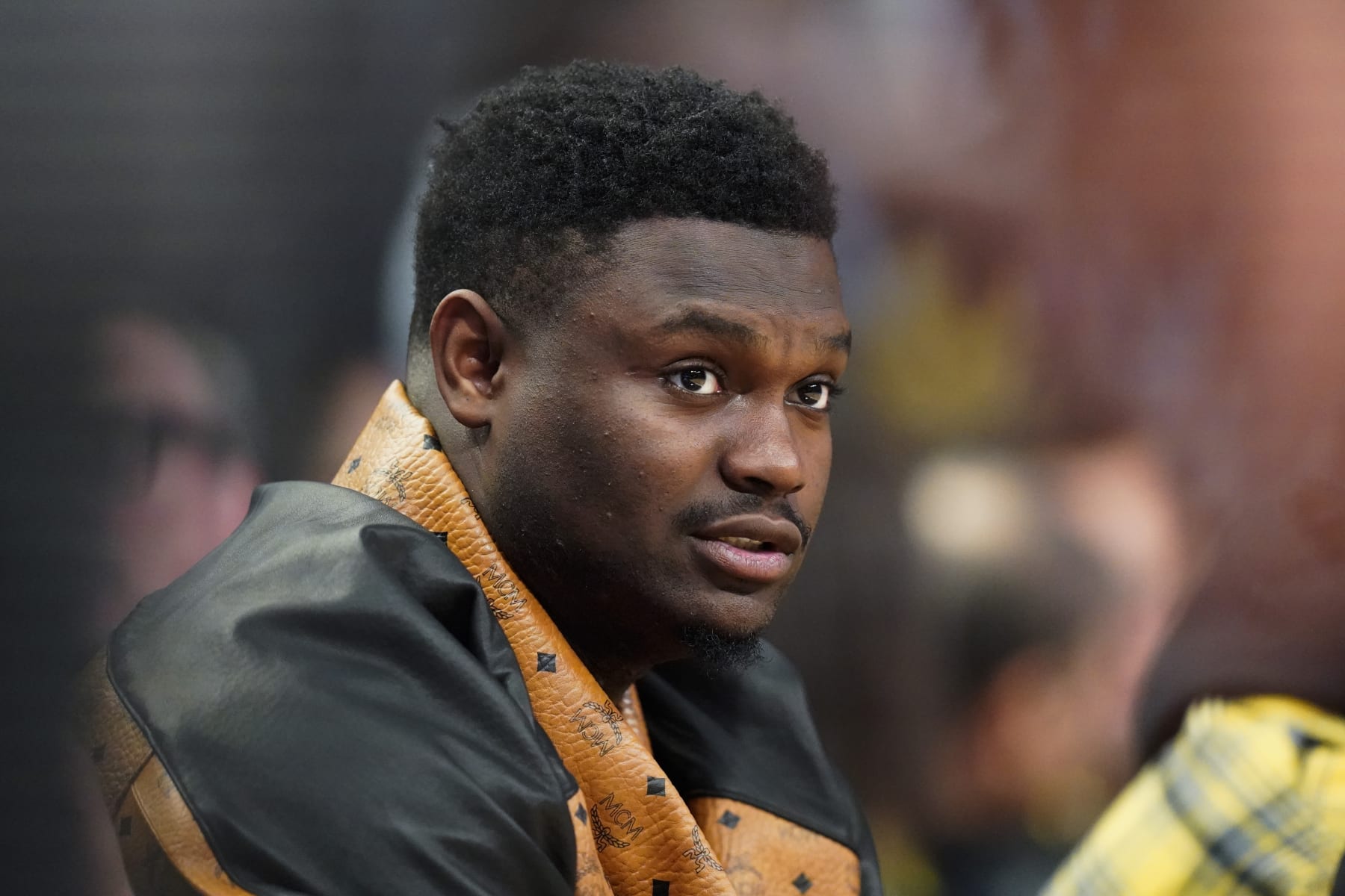 NBA All Star Zion Williamson, of the New Orleans Pelicans, watches an NBA Rising Stars semifinal basketball game, Friday, Feb. 17, 2023, in Salt Lake City. (AP Photo/Rick Bowmer)