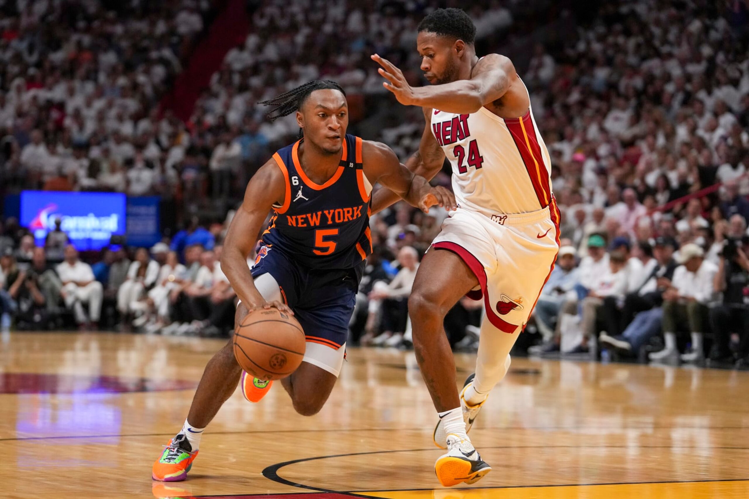 MIAMI, FLORIDA - MAY 06: Immanuel Quickley #5 of the New York Knicks drives past Haywood Highsmith #24 of the Miami Heat during game three of the Eastern Conference Semifinals at Kaseya Center on May 06, 2023 in Miami, Florida.  NOTE TO USER: User expressly acknowledges and agrees that,  by downloading and or using this photograph,  User is consenting to the terms and conditions of the Getty Images License Agreement. (Photo by Eric Espada/Getty Images)