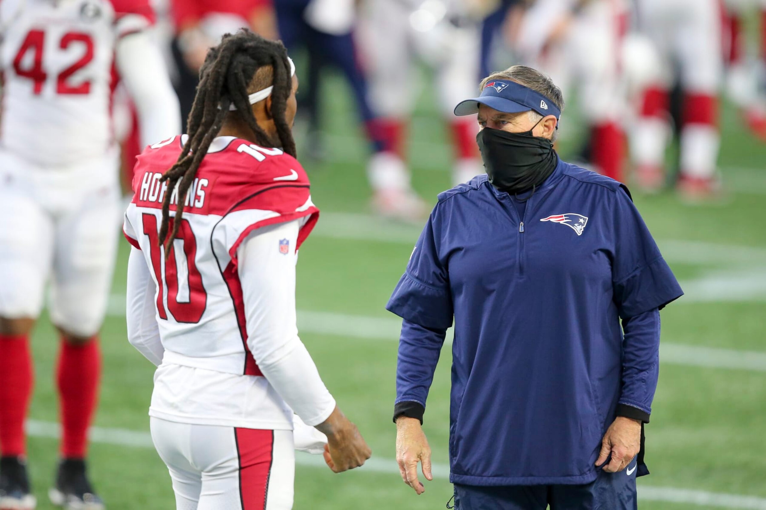 New England Patriots head coach Bill Belichick talks with Arizona Cardinals wide receiver DeAndre Hopkins (10) following an NFL football game, Sunday, Nov. 29, 2020, in Foxborough, Mass. (AP Photo/Stew Milne)