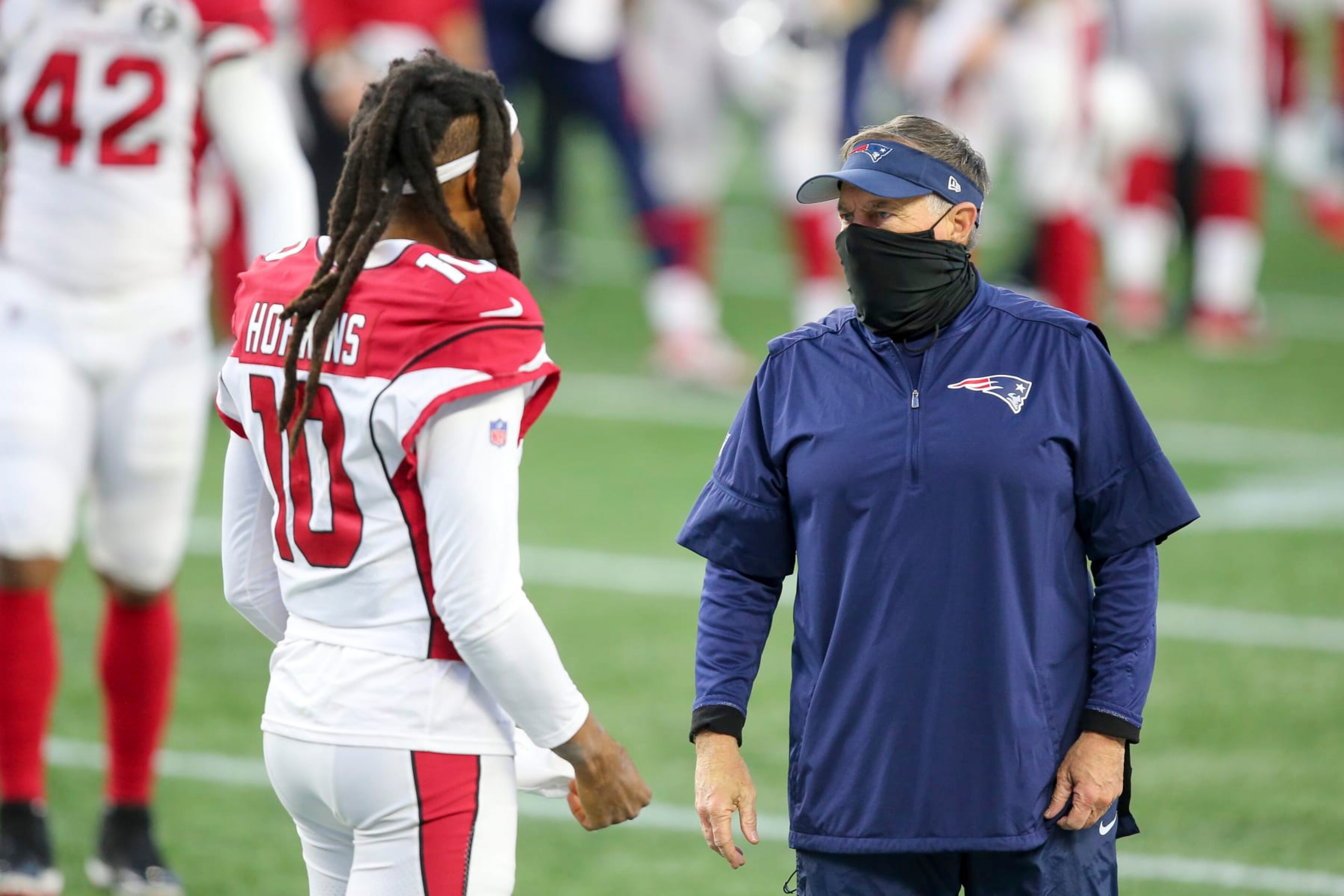 New England Patriots head coach Bill Belichick talks with Arizona Cardinals wide receiver DeAndre Hopkins (10) following an NFL football game, Sunday, Nov. 29, 2020, in Foxborough, Mass. (AP Photo/Stew Milne)