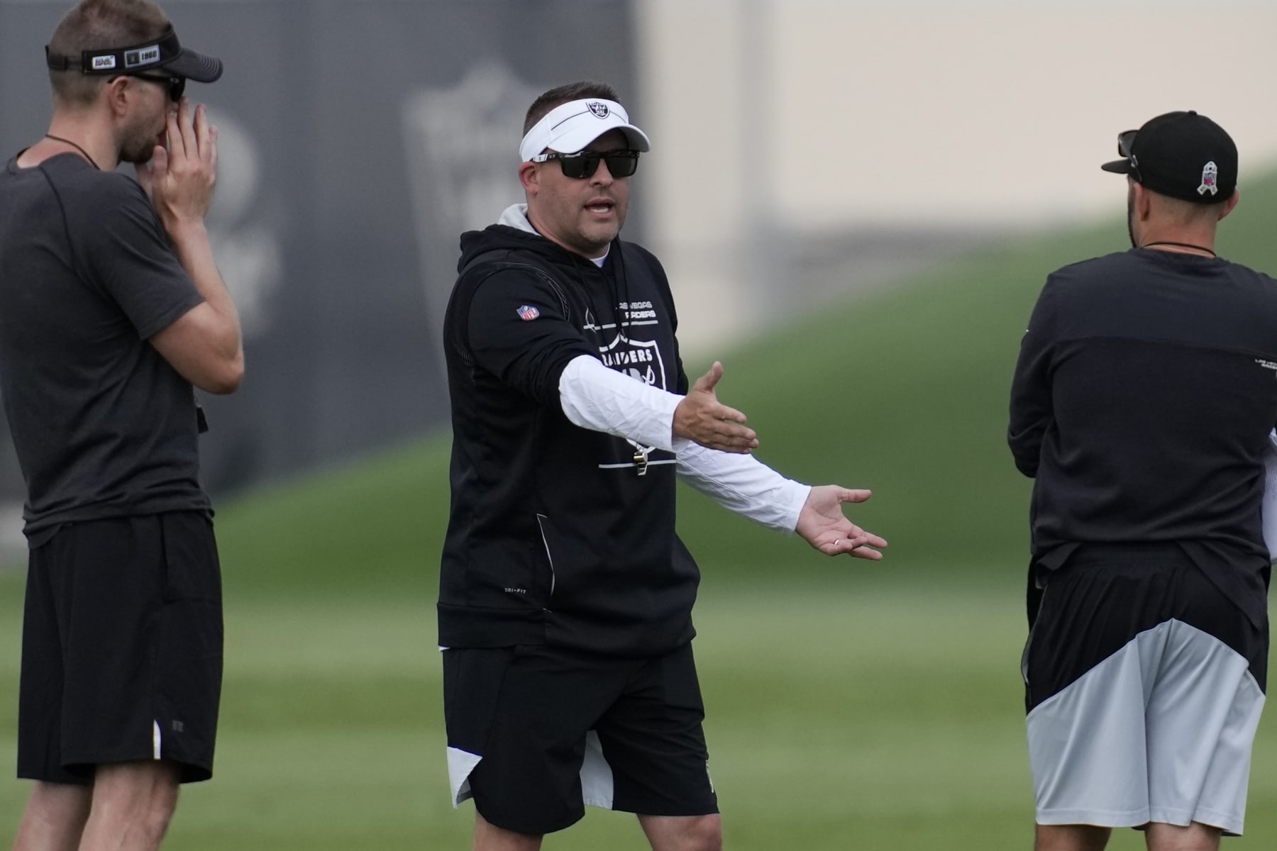 Las Vegas Raiders head coach Josh McDaniels motions during an NFL football practice at the team's training facility Wednesday, June 7, 2023, in Henderson, Nev. (AP Photo/John Locher)