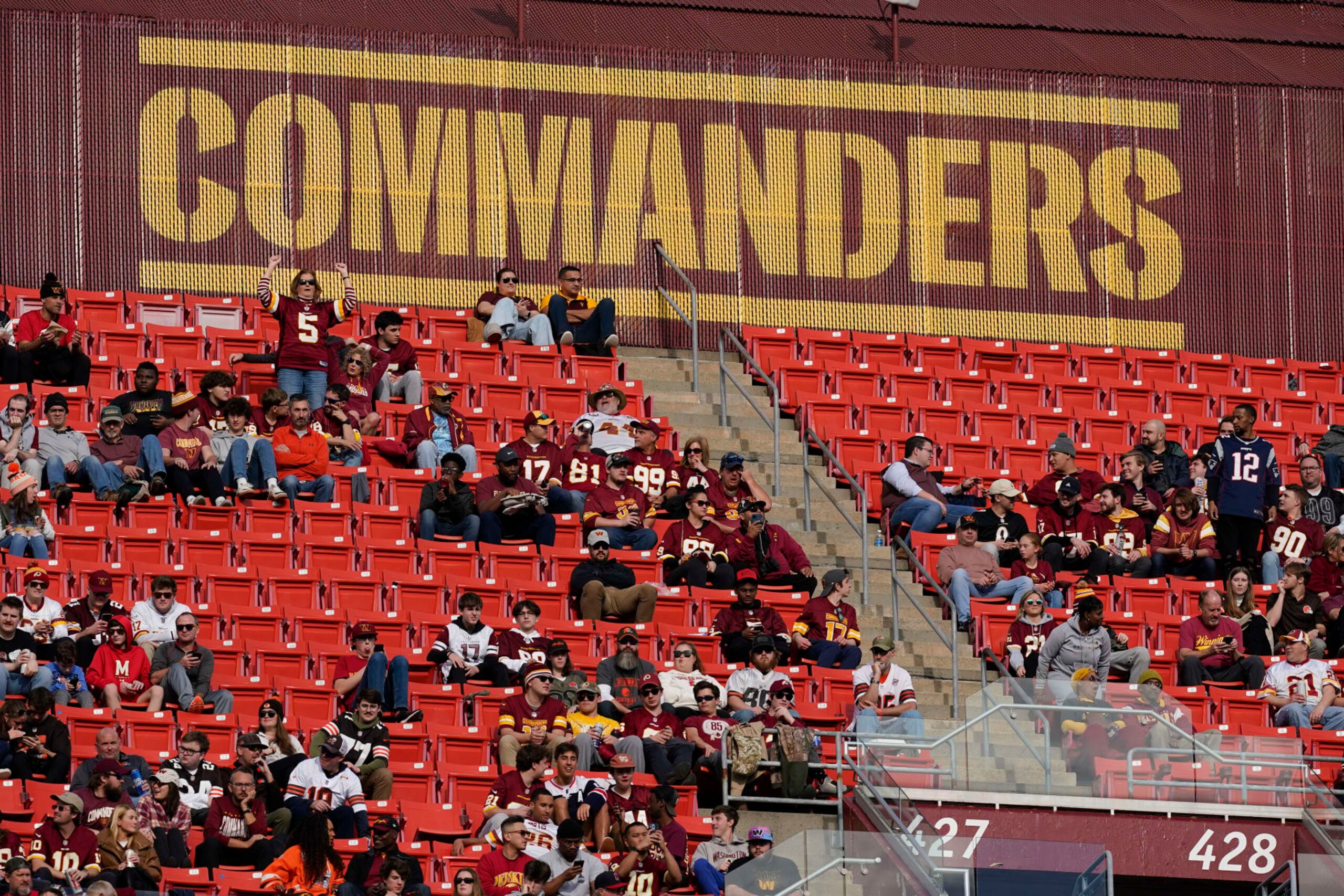 FILE - Fans watch the second half of an NFL football game between the Cleveland Browns and the Washington Commanders, Sunday, Jan. 1, 2023, at FedEx Field in Landover, Md. A group led by Josh Harris and Mitchell Rales that includes Magic Johnson has an agreement in principle to buy the NFL's Washington Commanders from longtime owner Dan Snyder for a North American professional sports team record $6 billion, according to a person with knowledge of the situation. The person spoke to The Associated Press on condition of anonymity Thursday, April 13, 2023, because the deal had not been announced. (AP Photo/Patrick Semansky, File) FILE - Fans watch the second half of an NFL football game between the Cleveland Browns and the Washington Commanders, Sunday, Jan. 1, 2023, at FedEx Field in Landover, Md. A group led by Josh Harris and Mitchell Rales that includes Magic Johnson has an agreement in principle to buy the NFL's Washington Commanders from longtime owner Dan Snyder for a North American professional sports team record $6 billion, according to a person with knowledge of the situation. The person spoke to The Associated Press on condition of anonymity Thursday, April 13, 2023, because the deal had not been announced. (AP Photo/Patrick Semansky, File)