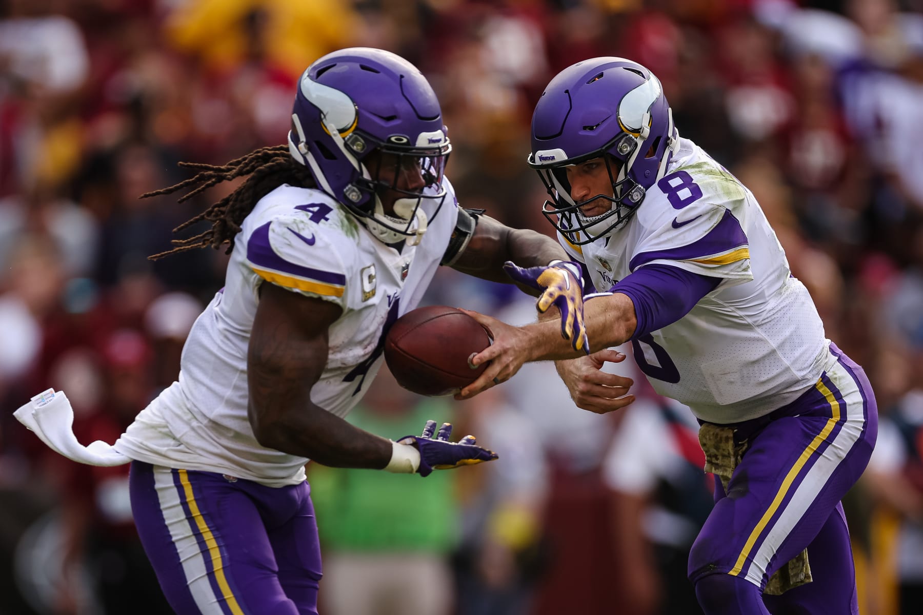 LANDOVER, MD - NOVEMBER 06: Kirk Cousins #8 of the Minnesota Vikings hands the ball off to Dalvin Cook #4 against the Washington Commanders during the second half of the game at FedExField on November 6, 2022 in Landover, Maryland. (Photo by Scott Taetsch/Getty Images)