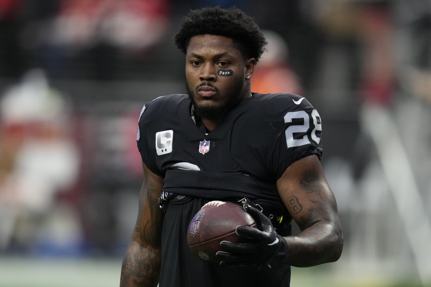 Las Vegas Raiders running back Josh Jacobs (28) warms up before an NFL football game against the Kansas City Chiefs, Wednesday, Jan. 11, 2023, in Las Vegas. (AP Photo/John Locher)
