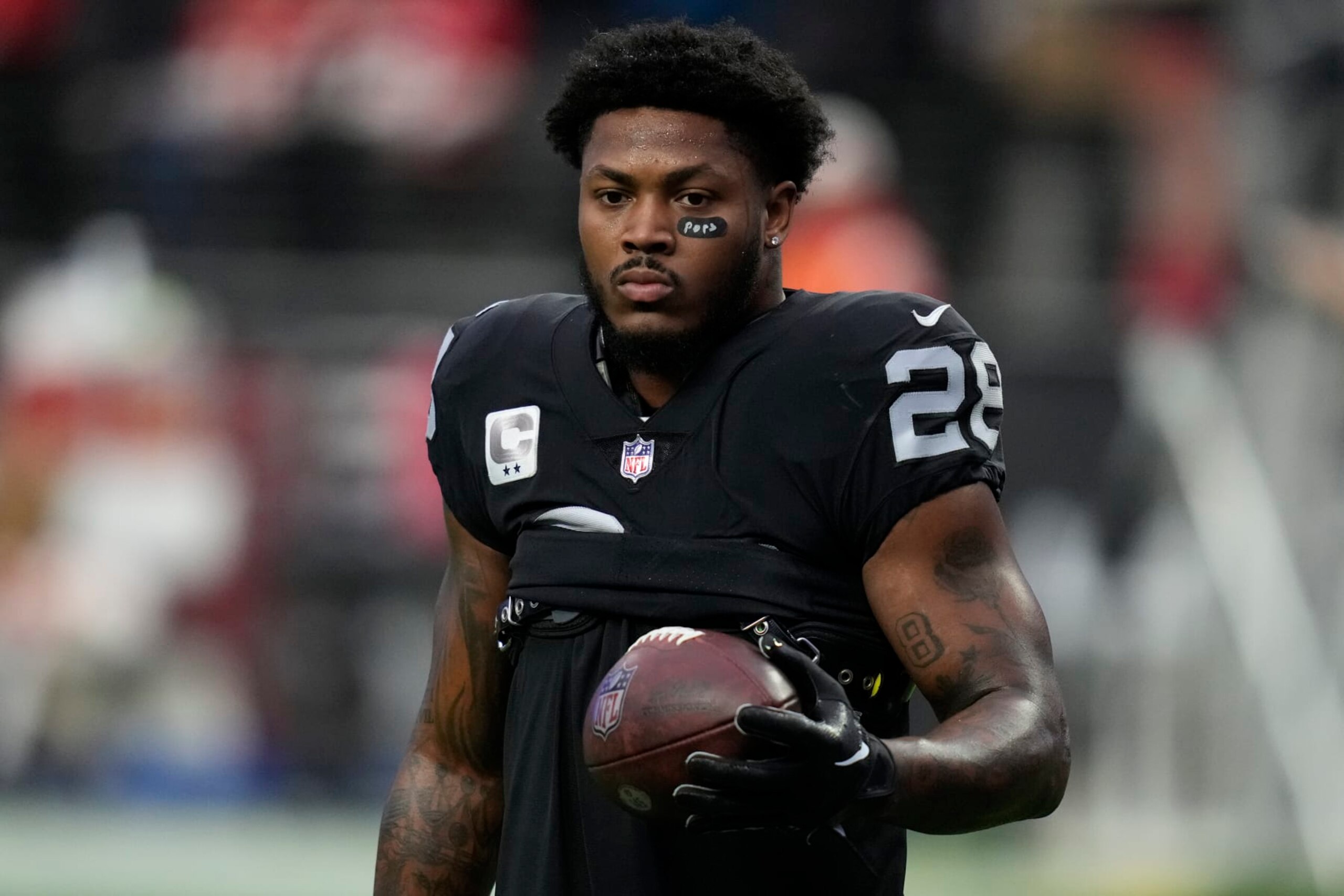 Las Vegas Raiders running back Josh Jacobs (28) warms up before an NFL football game against the Kansas City Chiefs, Wednesday, Jan. 11, 2023, in Las Vegas. (AP Photo/John Locher)