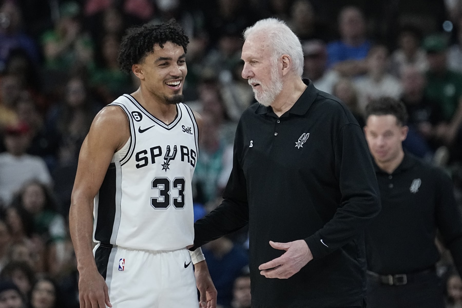 San Antonio Spurs guard Tre Jones (33) and San Antonio Spurs head coach Gregg Popovich during the second half of an NBA basketball game against the Detroit Pistons in San Antonio, Saturday, Jan. 7, 2023. (AP Photo/Eric Gay)