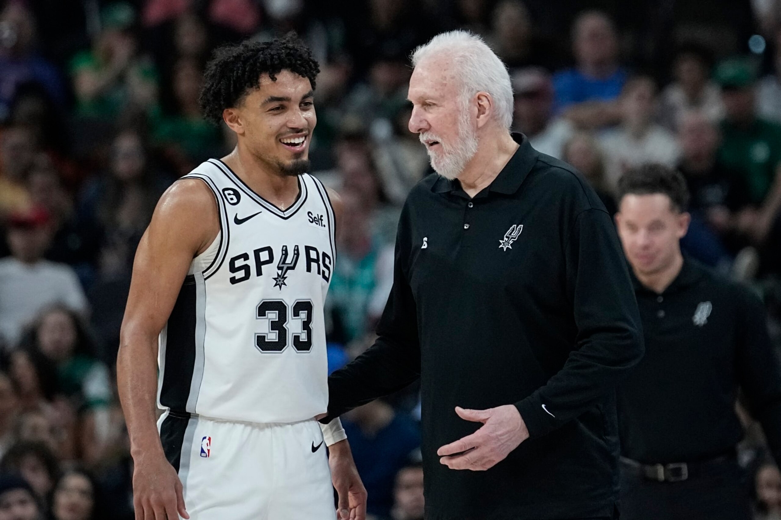 San Antonio Spurs guard Tre Jones (33) and San Antonio Spurs head coach Gregg Popovich during the second half of an NBA basketball game against the Detroit Pistons in San Antonio, Saturday, Jan. 7, 2023. (AP Photo/Eric Gay)