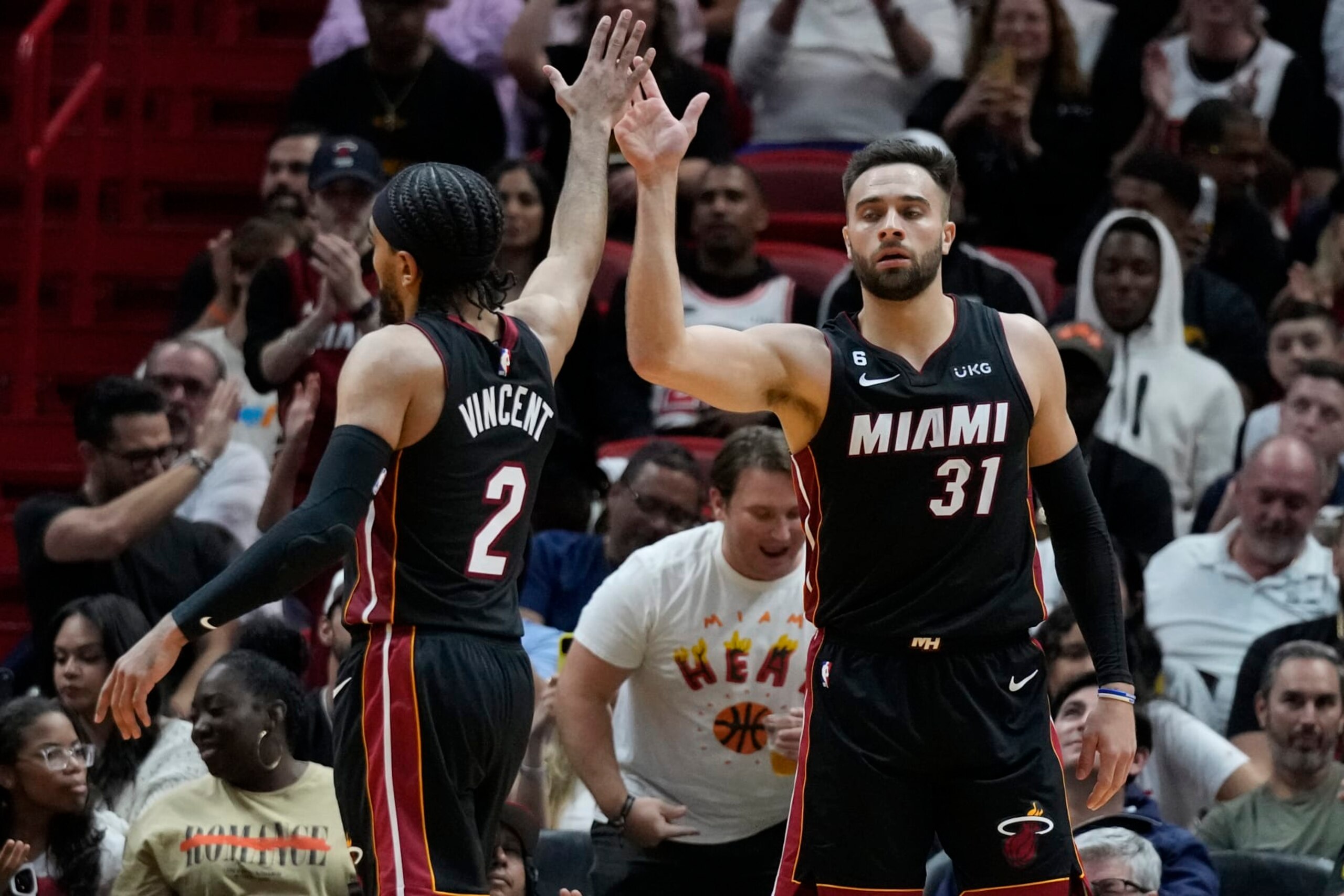 Miami Heat guards Max Strus (31) and Gabe Vincent (2) congratulate each other after a play during the second half of an NBA basketball game against the Milwaukee Bucks, Thursday, Jan. 12, 2023, in Miami. (AP Photo/Wilfredo Lee)