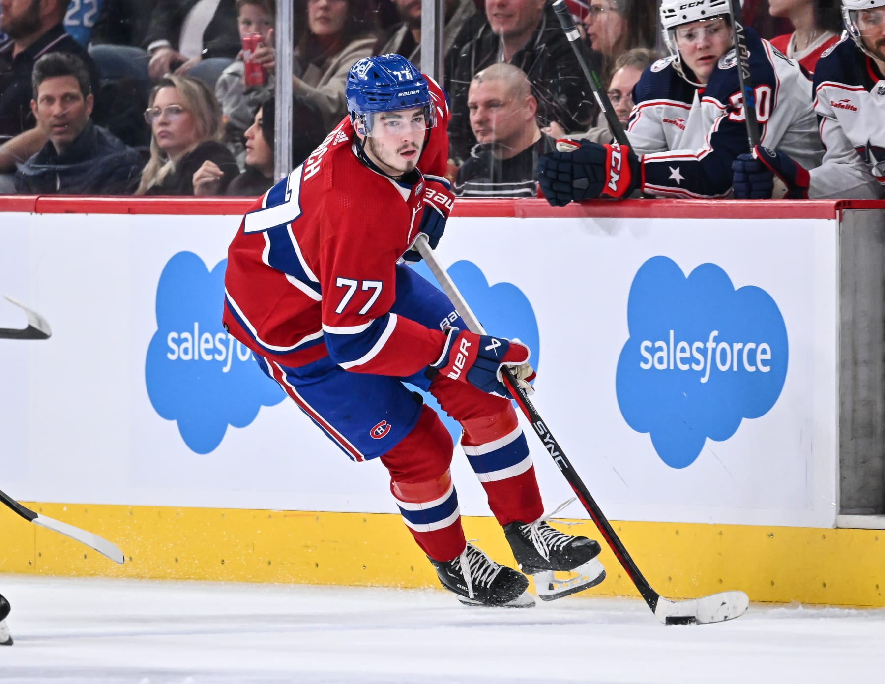 MONTREAL, CANADA - MARCH 25:  Kirby Dach #77 of the Montreal Canadiens skates the puck during the second period against the Columbus Blue Jackets at Centre Bell on March 25, 2023 in Montreal, Quebec, Canada.  The Montreal Canadiens defeated the Columbus Blue Jackets 8-2.  (Photo by Minas Panagiotakis/Getty Images)
