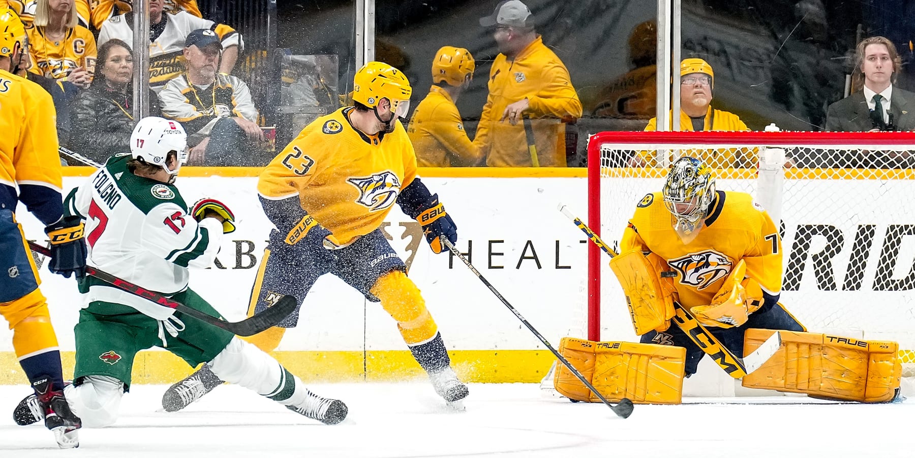 NASHVILLE, TENNESSEE - APRIL 13: Juuse Saros #74 of the Nashville Predators makes the save against Marcus Foligno #17 of the Minnesota Wild during an NHL game at Bridgestone Arena on April 13, 2023 in Nashville, Tennessee. (Photo by John Russell/NHLI via Getty Images)