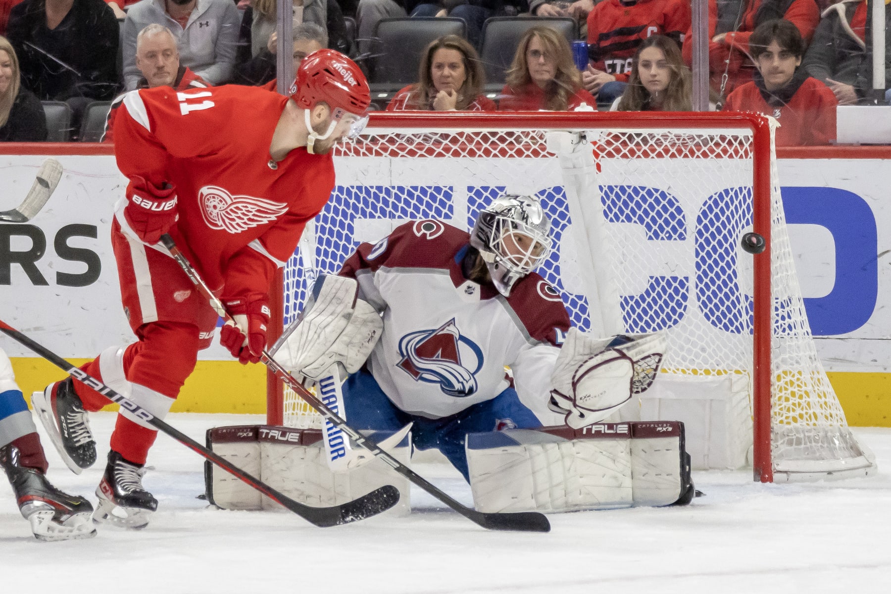 DETROIT, MI - MARCH 18: Alexandar Georgiev #40 of the Colorado Avalanche makes a glove save as Filip Zadina #11 of the Detroit Red Wings closes in during the first period of an NHL game at Little Caesars Arena on March 18, 2023 in Detroit, Michigan. (Photo by Dave Reginek/NHLI via Getty Images)