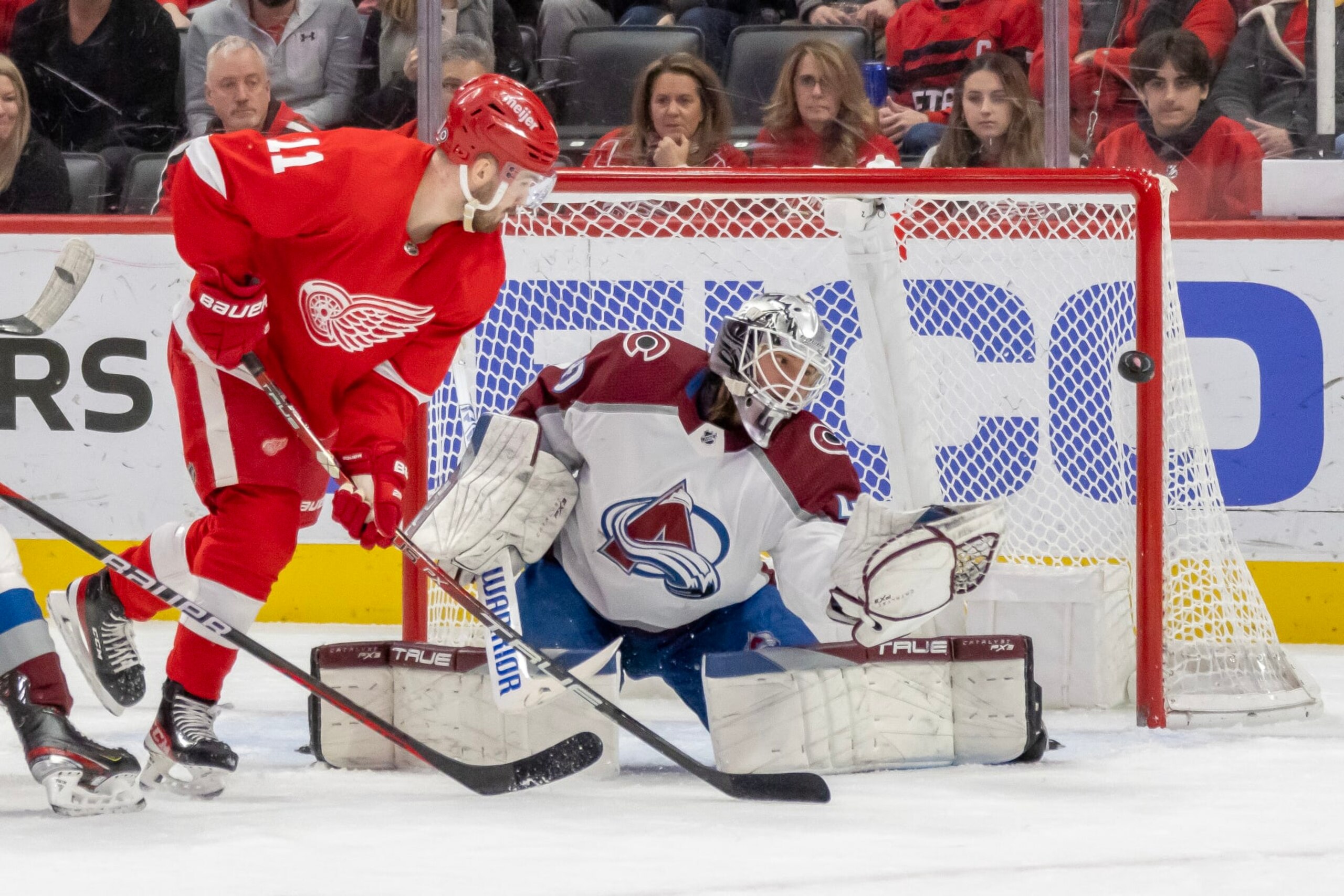 DETROIT, MI - MARCH 18: Alexandar Georgiev #40 of the Colorado Avalanche makes a glove save as Filip Zadina #11 of the Detroit Red Wings closes in during the first period of an NHL game at Little Caesars Arena on March 18, 2023 in Detroit, Michigan. (Photo by Dave Reginek/NHLI via Getty Images)