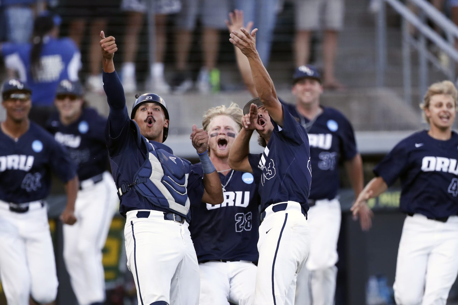 Oral Roberts' Jacob Godman, left, Drew Stahl, center, and Dalton Patten, right, celebrate their 11-6 win over Oregon in an NCAA college baseball tournament super regional game, Sunday, June 11, 2023, in Eugene, Ore. (AP Photo/Amanda Loman)