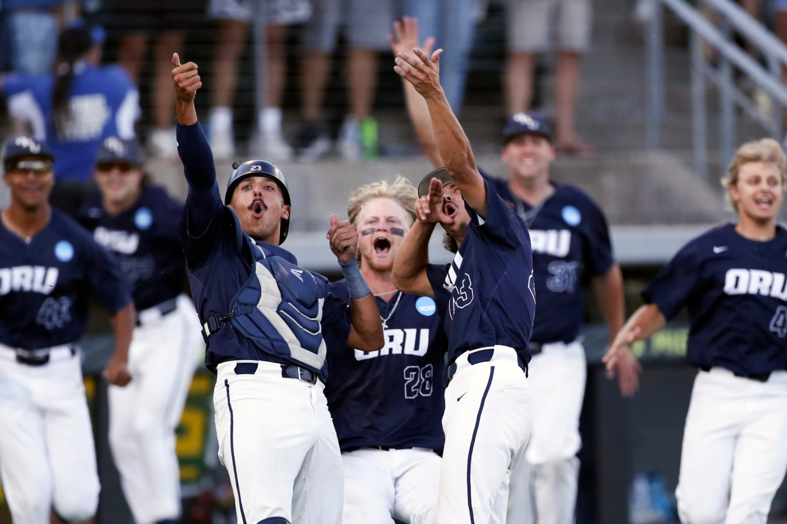 Oral Roberts' Jacob Godman, left, Drew Stahl, center, and Dalton Patten, right, celebrate their 11-6 win over Oregon in an NCAA college baseball tournament super regional game, Sunday, June 11, 2023, in Eugene, Ore. (AP Photo/Amanda Loman)