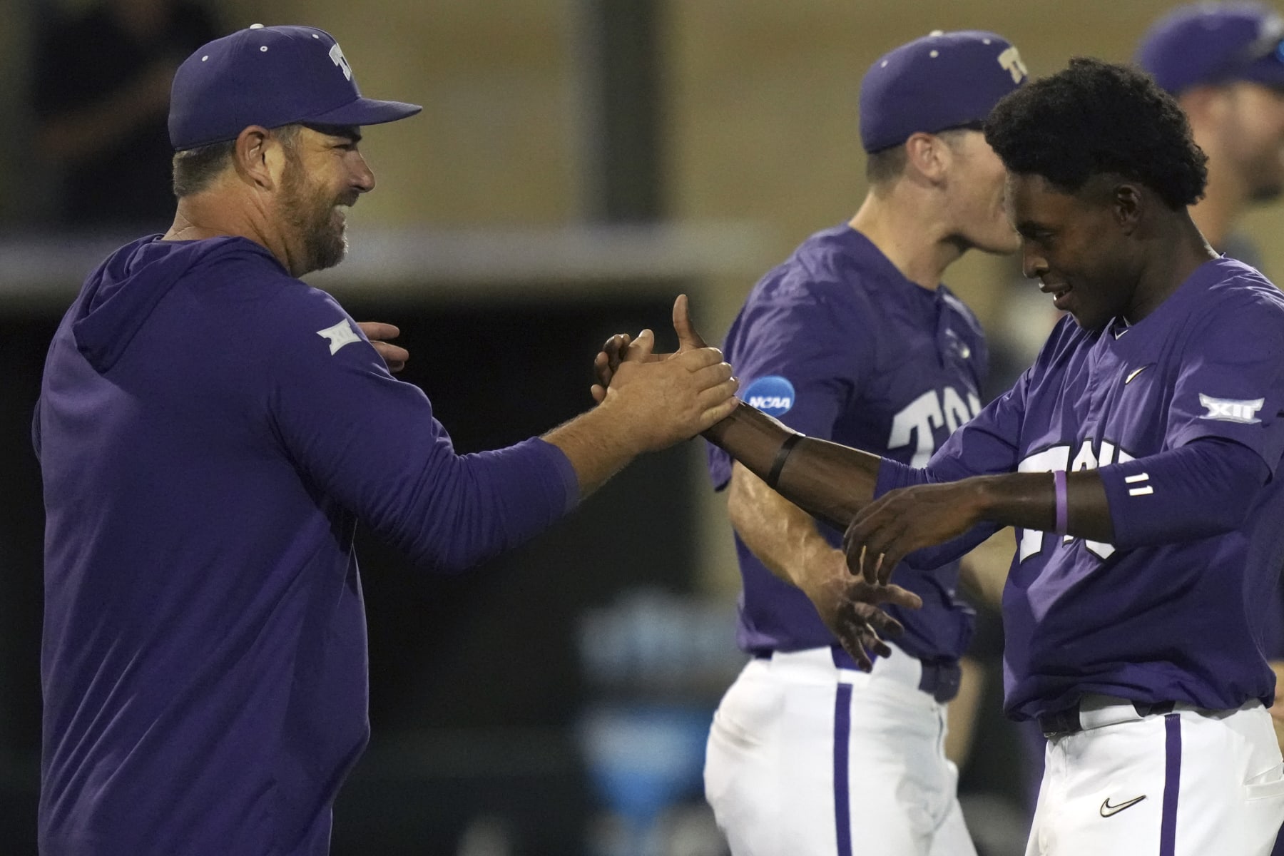 TCU baseball coach Kirk Saarloos, left, congratulates Tre Richardson after an NCAA college baseball tournament super regional game against Indiana State in Fort Worth, Texas, Saturday, June 10, 2023. (AP Photo/LM Otero)