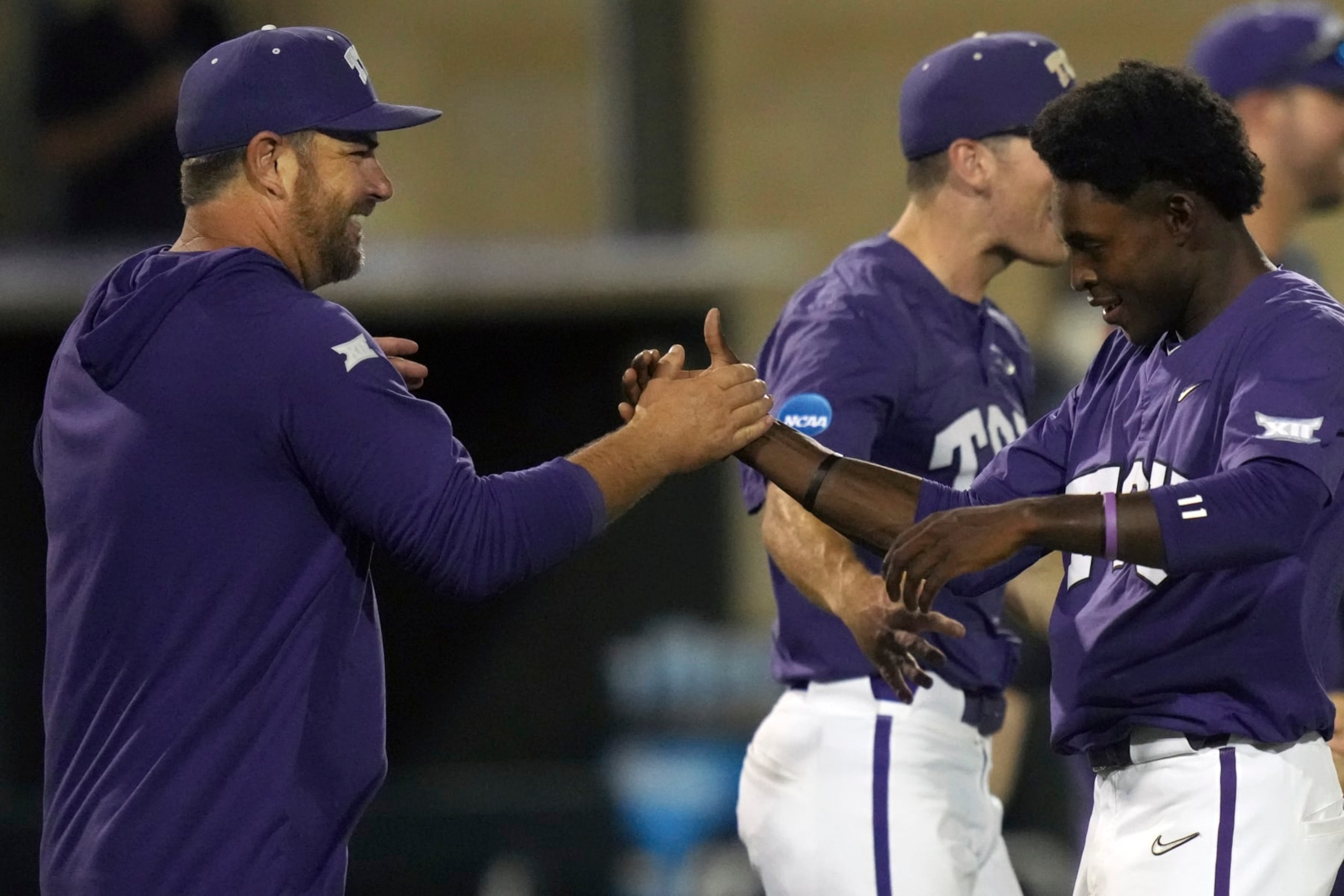 TCU baseball coach Kirk Saarloos, left, congratulates Tre Richardson after an NCAA college baseball tournament super regional game against Indiana State in Fort Worth, Texas, Saturday, June 10, 2023. (AP Photo/LM Otero)
