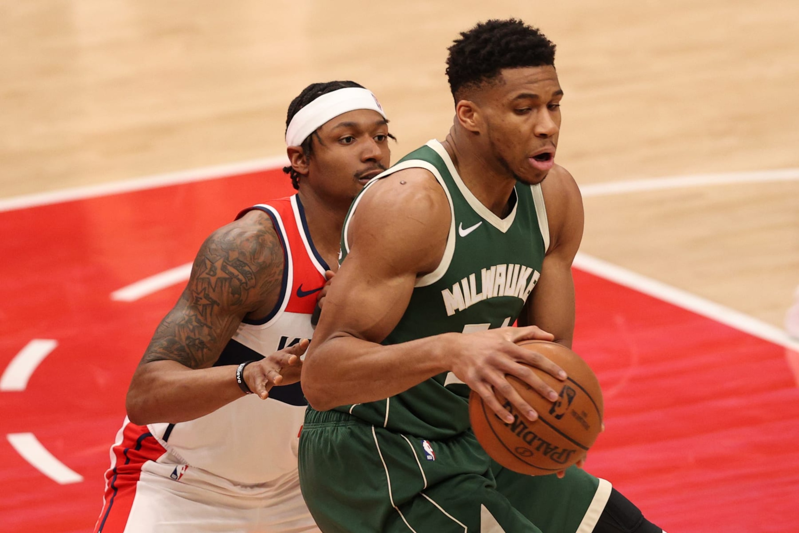 WASHINGTON, DC - MARCH 15: Giannis Antetokounmpo #34 of the Milwaukee Bucks is guarded by Bradley Beal #3 of the Washington Wizards during the first half at Capital One Arena on March 15, 2021 in Washington, DC. NOTE TO USER: User expressly acknowledges and agrees that, by downloading and or using this photograph, User is consenting to the terms and conditions of the Getty Images License Agreement. (Photo by Patrick Smith/Getty Images)
