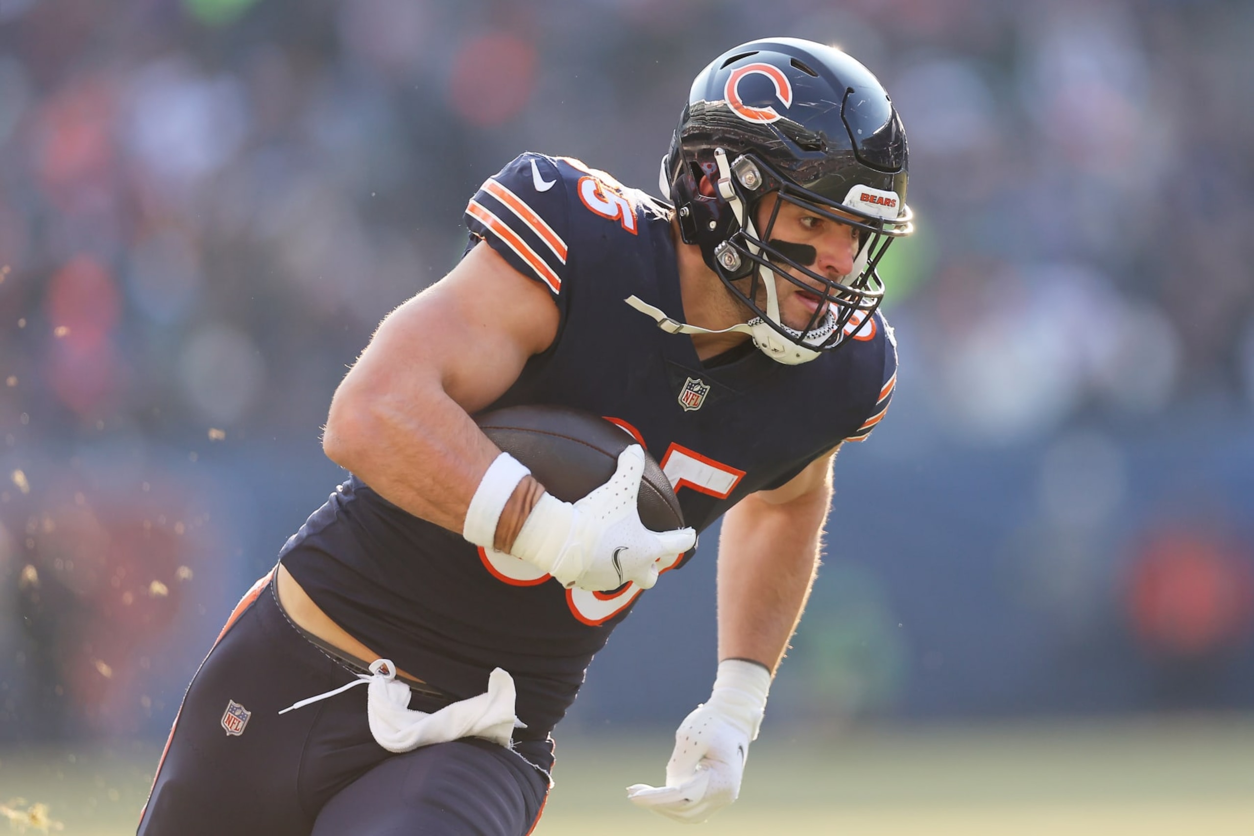 CHICAGO, ILLINOIS - JANUARY 08:  Tight end Cole Kmet #85 of the Chicago Bears carries the ball after making a catch during the 3rd quarter of the game against the Minnesota Vikings at Soldier Field on January 08, 2023 in Chicago, Illinois. (Photo by Michael Reaves/Getty Images)