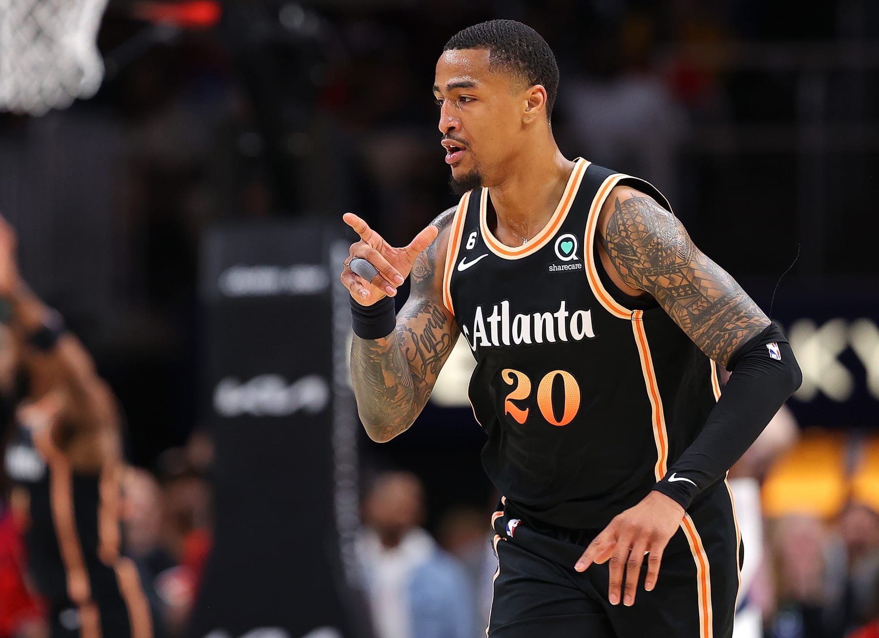 ATLANTA, GEORGIA - APRIL 02:  John Collins #20 of the Atlanta Hawks reacts after shooting a three-point basket against the Dallas Mavericks during the second quarter at State Farm Arena on April 02, 2023 in Atlanta, Georgia.  NOTE TO USER: User expressly acknowledges and agrees that, by downloading and or using this photograph, User is consenting to the terms and conditions of the Getty Images License Agreement.  (Photo by Kevin C. Cox/Getty Images)