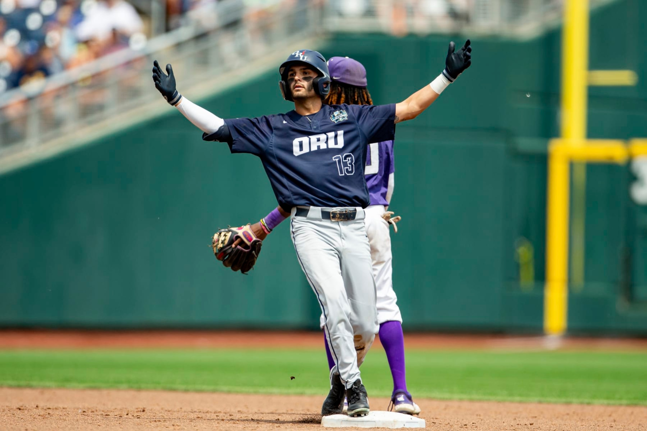 Oral Roberts' Justin Quinn (13) celebrates after a double against TCU in the sixth inning of a baseball game at the NCAA College World Series in Omaha, Neb., Friday, June 16, 2023. (AP Photo/John Peterson) Oral Roberts' Justin Quinn (13) celebrates after a double against TCU in the sixth inning of a baseball game at the NCAA College World Series in Omaha, Neb., Friday, June 16, 2023. (AP Photo/John Peterson)