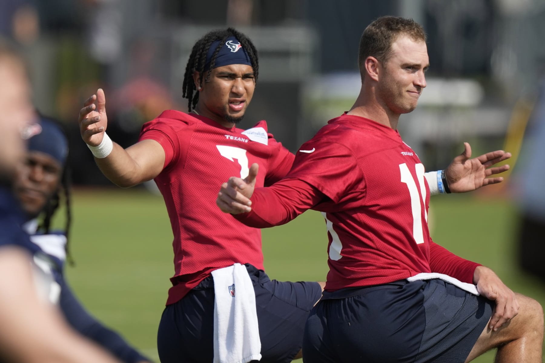 Houston Texans quarterbacks C.J. Stroud (7) and Davis Mills(10) stretch during an organized team activity at the football team's training facility Tuesday, May 23, 2023, in Houston. (AP Photo/David J. Phillip)