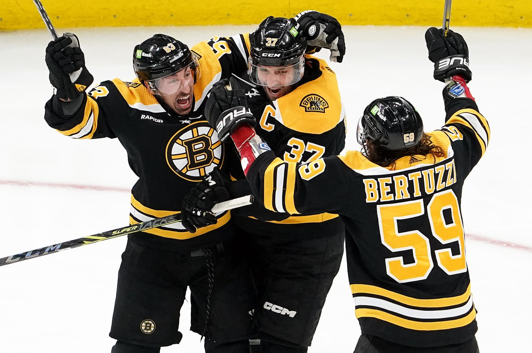 Boston, MA - April 26: Boston Bruins LW Tyler Bertuzzi celebrates with teammates Brad Marchand and Patrice Bergeron in the third period. The Bruins lost to the Florida Panthers, 4-3, in Game 5 of their Eastern Conference First Round Series. (Photo by Barry Chin/The Boston Globe via Getty Images)