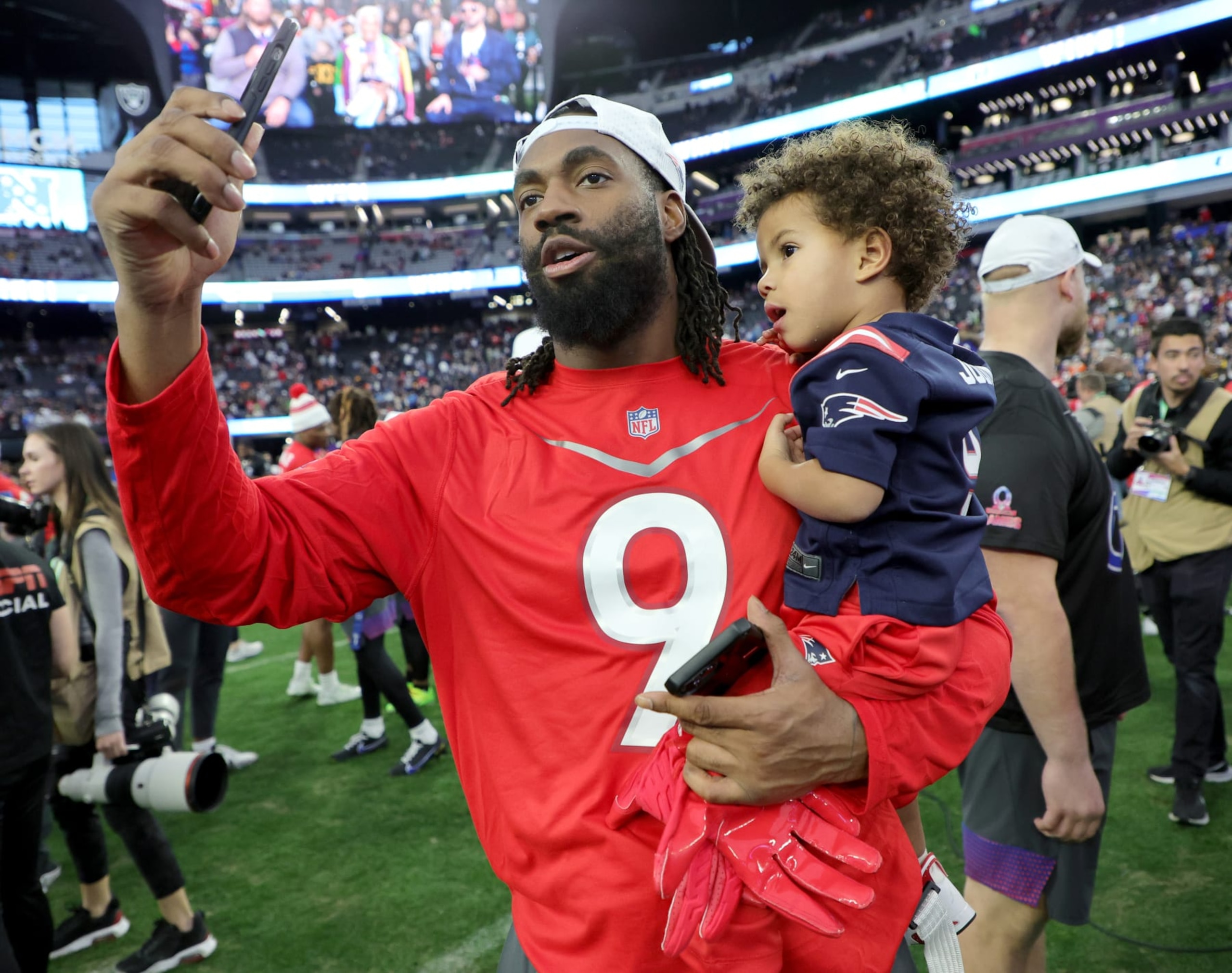 LAS VEGAS, NEVADA - FEBRUARY 05: Matthew Judon #9 of the New England Patriots and AFC carries his son Leo Judon on the field after the 2023 NFL Pro Bowl Games at Allegiant Stadium on February 05, 2023 in Las Vegas, Nevada. (Photo by Ethan Miller/Getty Images)