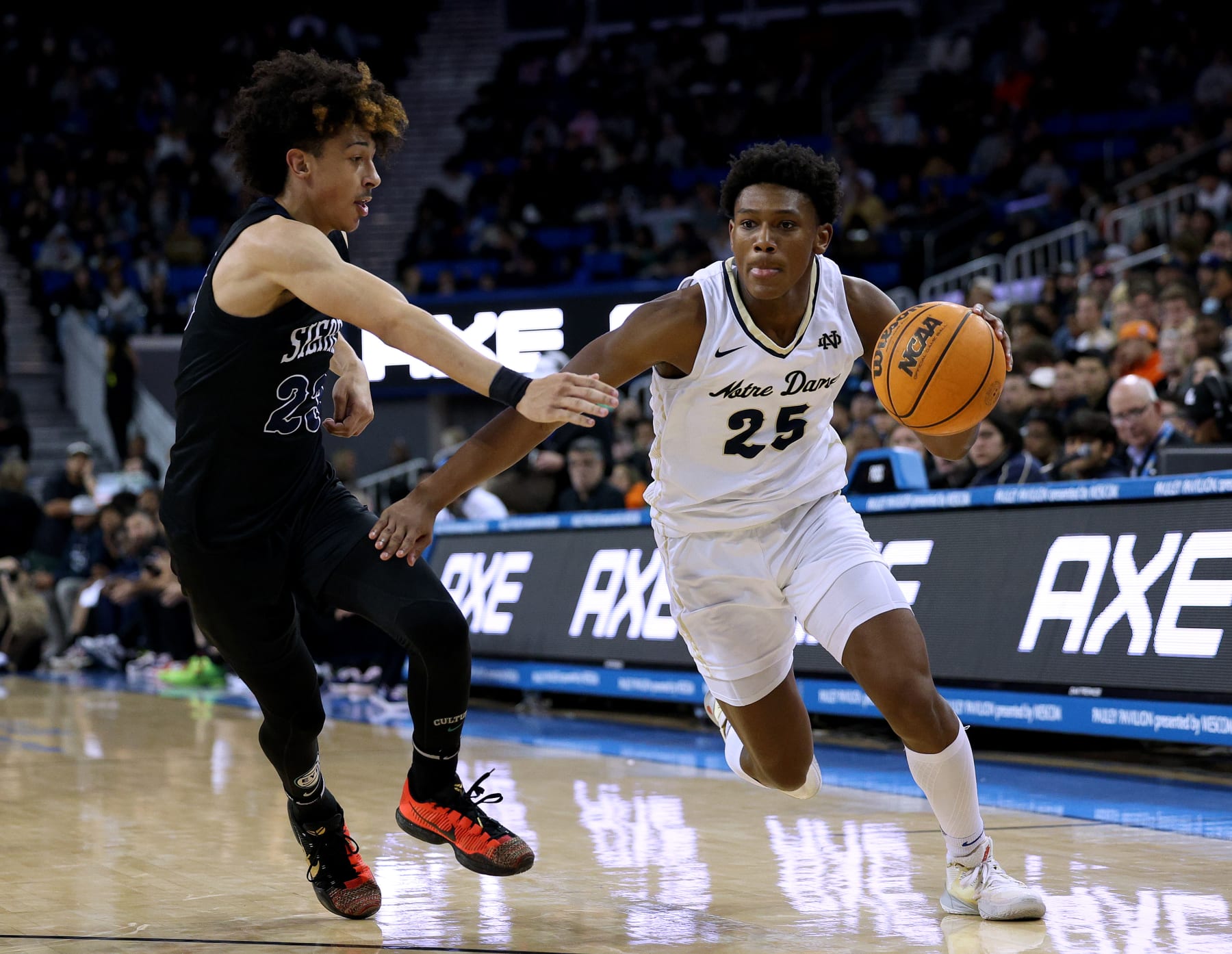LOS ANGELES, CALIFORNIA - JANUARY 27: Mercy Miller #25 of the Notre Dame Knights drives to the basket on Dylan Metoyer of the Sierra Canyon Trailblazers during a 66-62 Knights win at UCLA Pauley Pavilion on January 27, 2023 in Los Angeles, California. (Photo by Harry How/Getty Images)