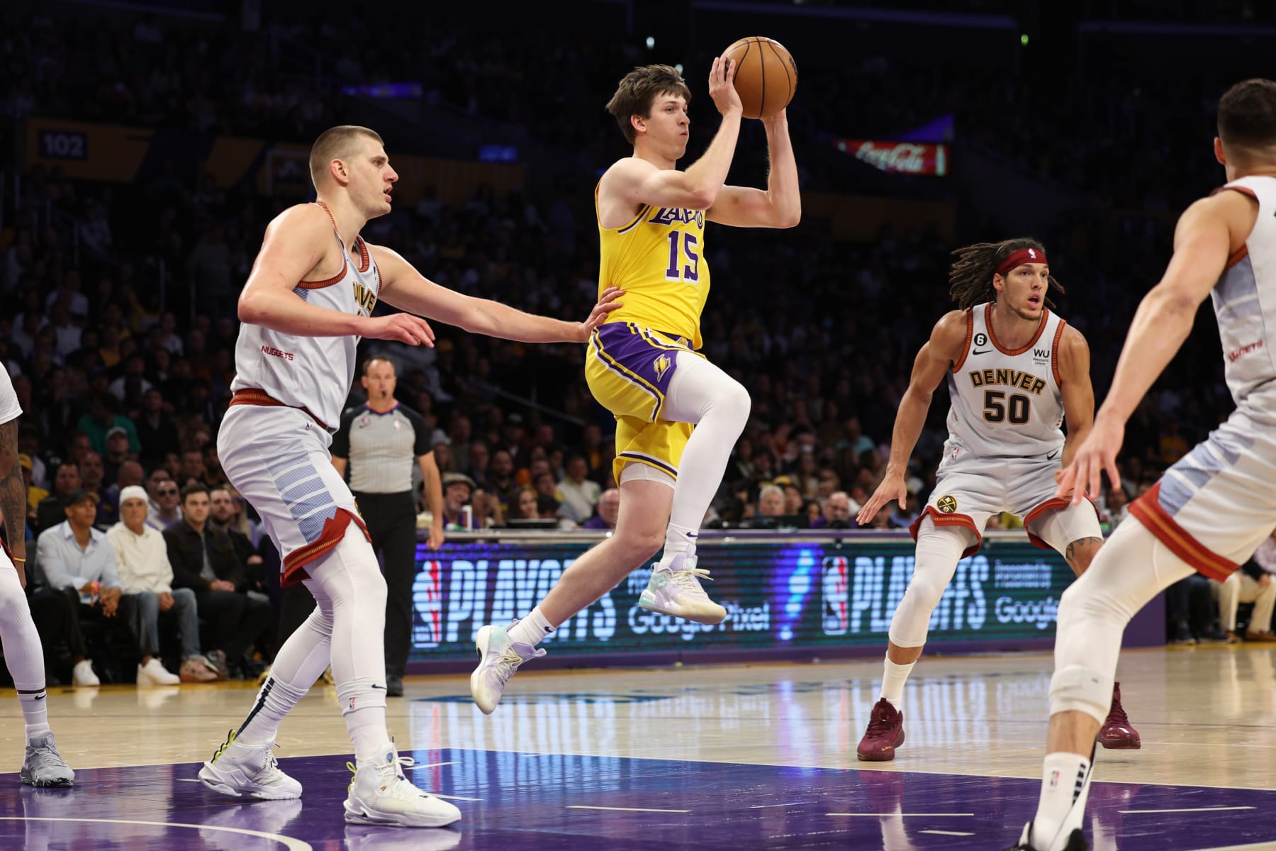 LOS ANGELES, CALIFORNIA - MAY 22: Austin Reaves #15 of the Los Angeles Lakers passes in front of Nikola Jokic #15 of the Denver Nuggets during the first quarter in game four of the Western Conference Finals at Crypto.com Arena on May 22, 2023 in Los Angeles, California. NOTE TO USER: User expressly acknowledges and agrees that, by downloading and or using this photograph, User is consenting to the terms and conditions of the Getty Images License Agreement. (Photo by Harry How/Getty Images)