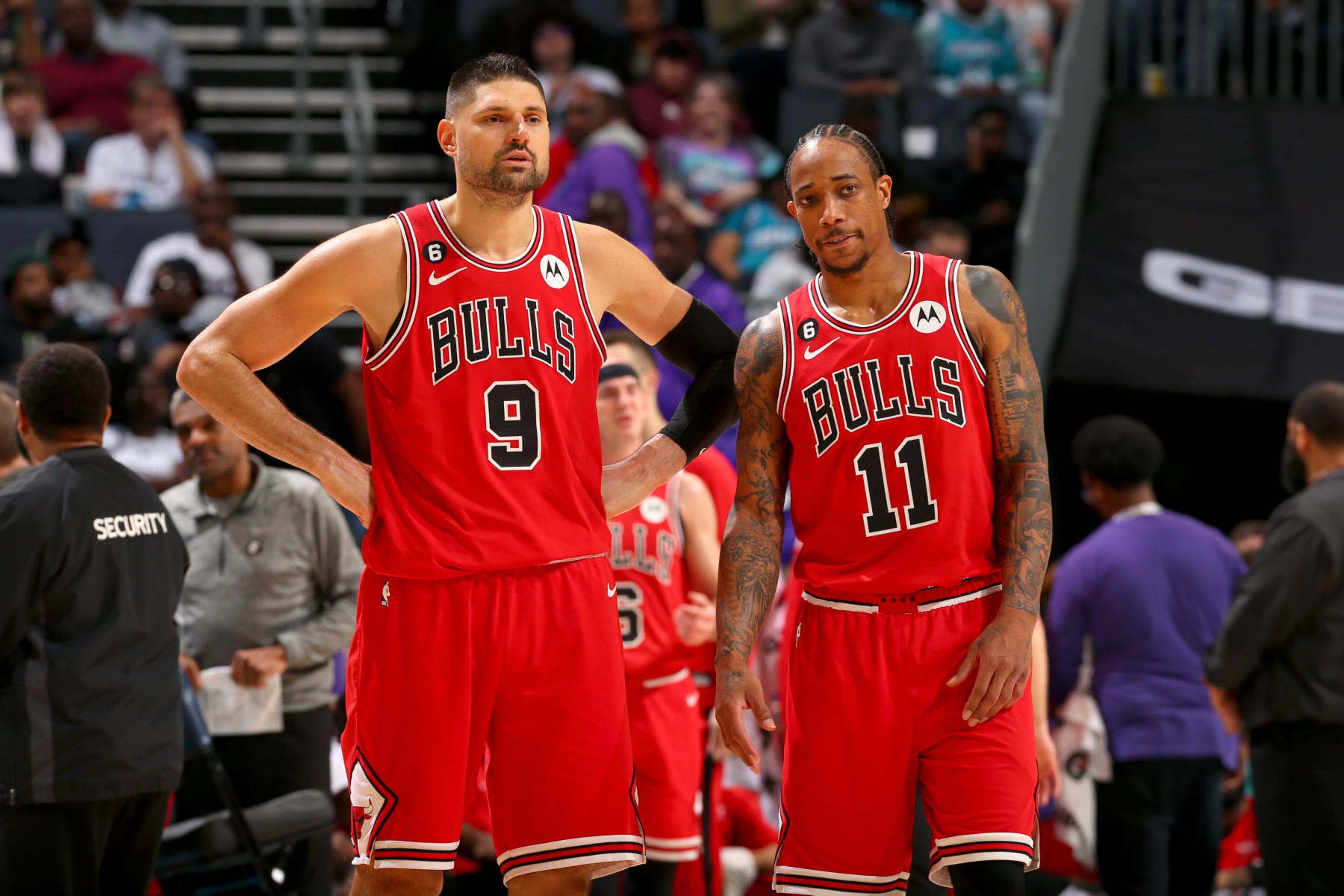 CHARLOTTE, NC - MARCH 31:  Nikola Vucevic #9 and DeMar DeRozan #11 of the Chicago Bulls look on during the game against the Charlotte Hornets on March 31, 2023 at Spectrum Center in Charlotte, North Carolina. NOTE TO USER: User expressly acknowledges and agrees that, by downloading and or using this photograph, User is consenting to the terms and conditions of the Getty Images License Agreement. Mandatory Copyright Notice: Copyright 2023 NBAE (Photo by Kent Smith/NBAE via Getty Images)